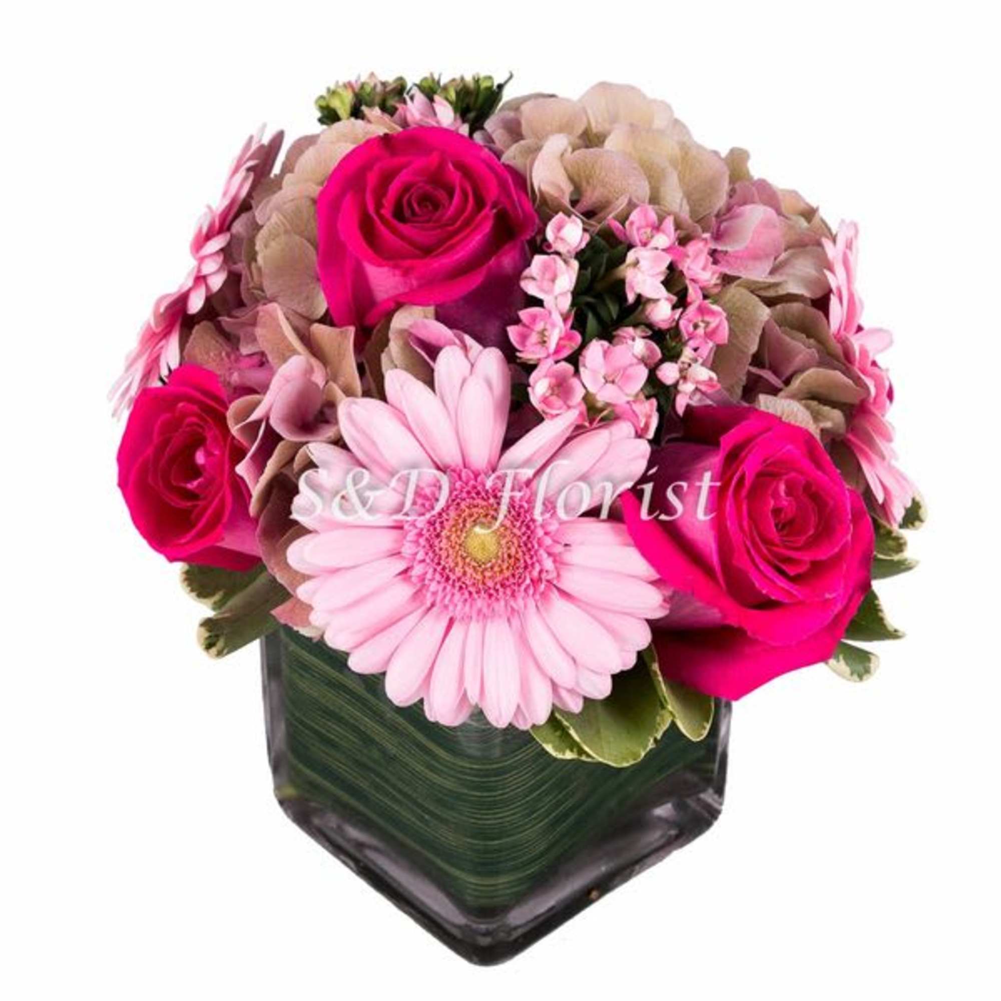 Pink roses and a gerbera daisy in a dark glass vase