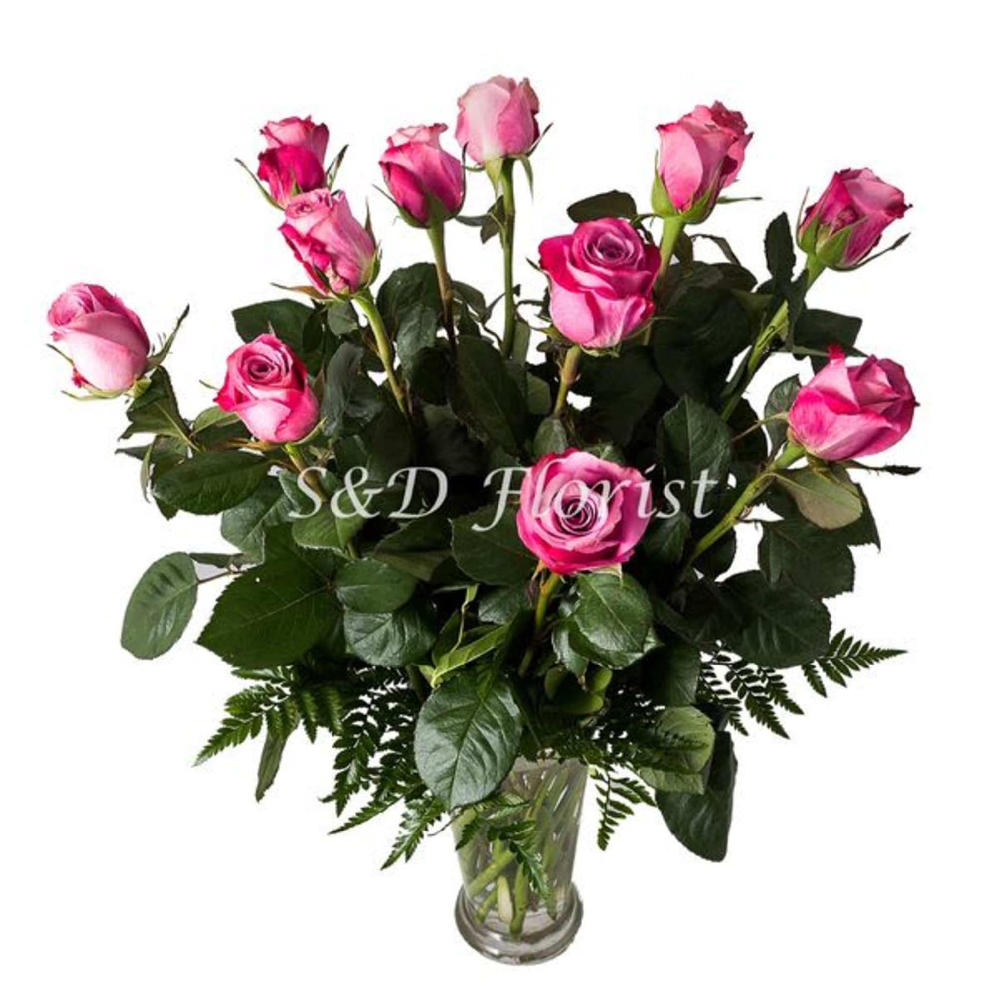 Pink roses arranged in a clear glass vase