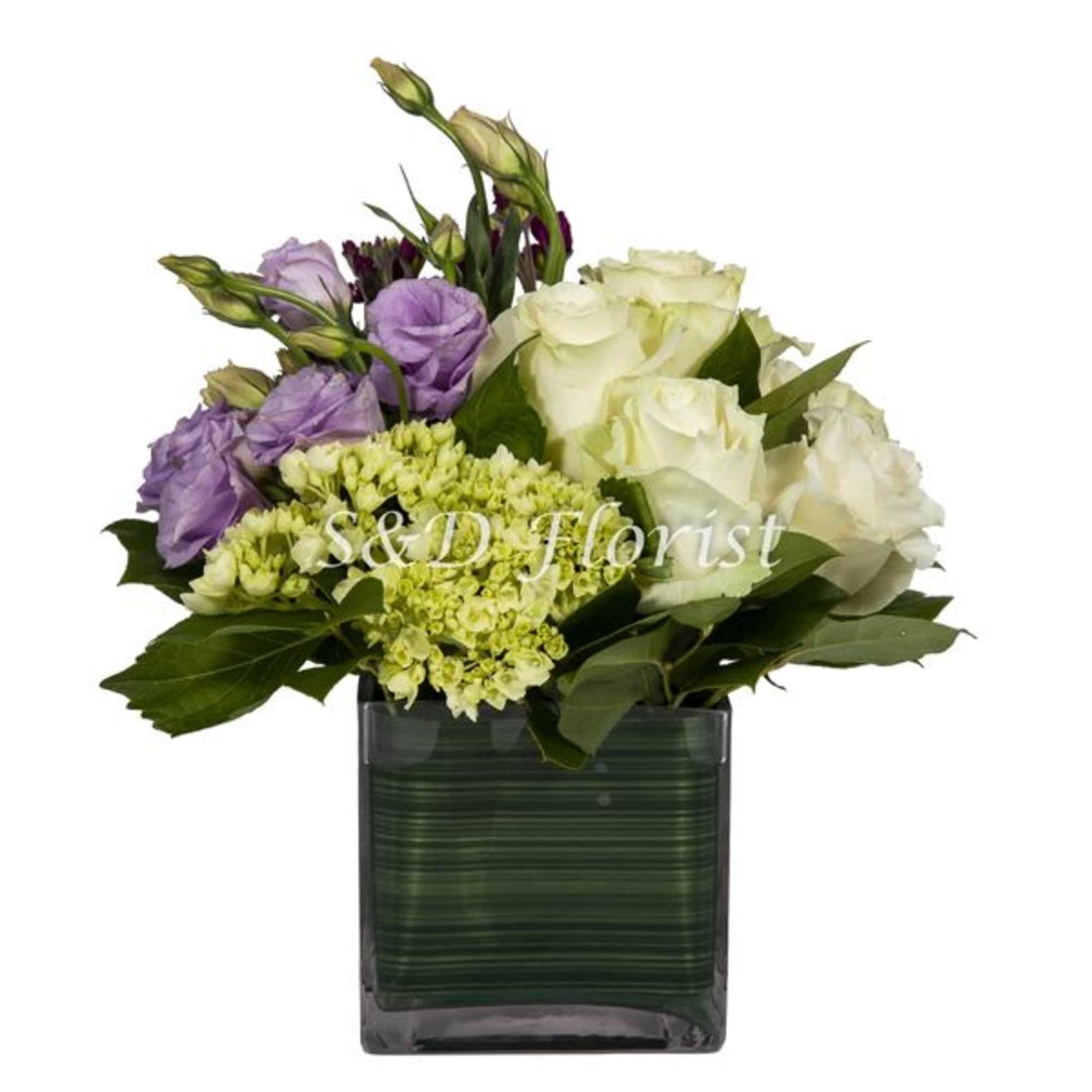 White and lavender roses in a square glass vase