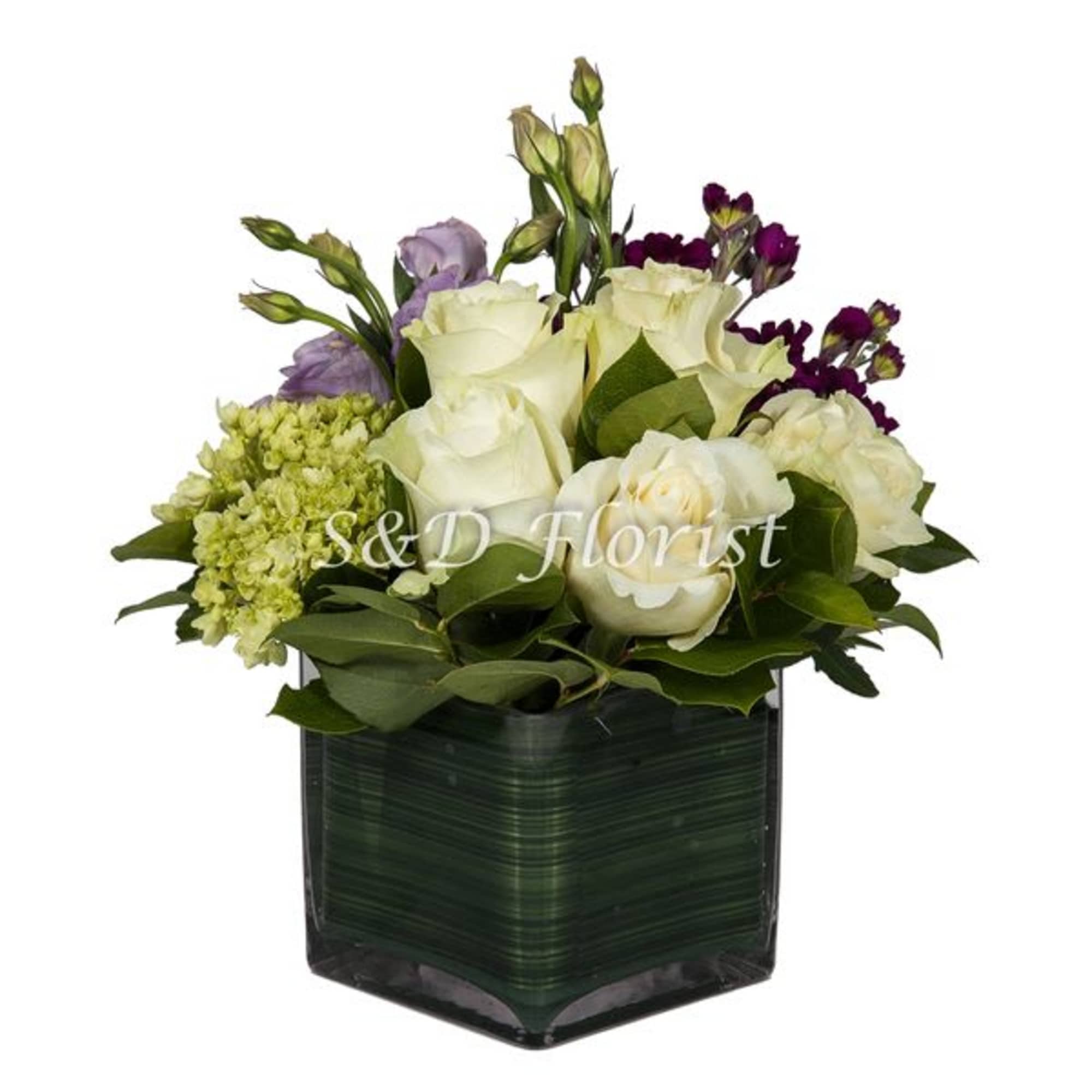 White roses and purple lisianthus in a dark square vase