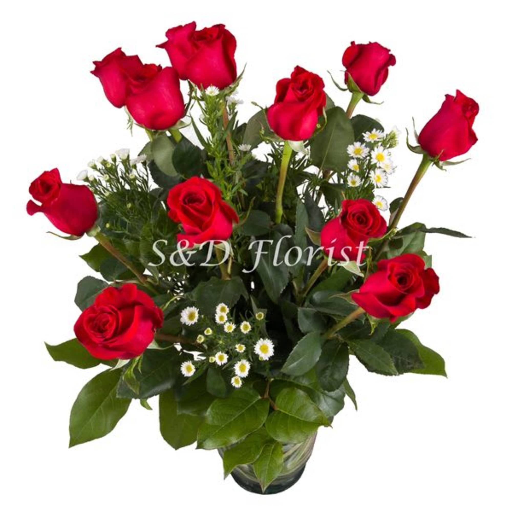 Bouquet of red roses with small white filler flowers in a glass vase