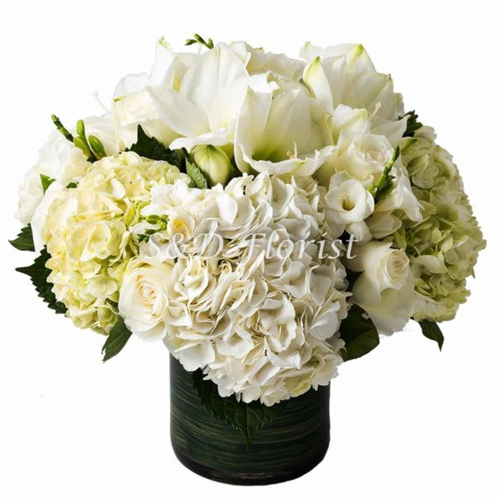 White floral arrangement in a dark vase with hydrangeas and lilies