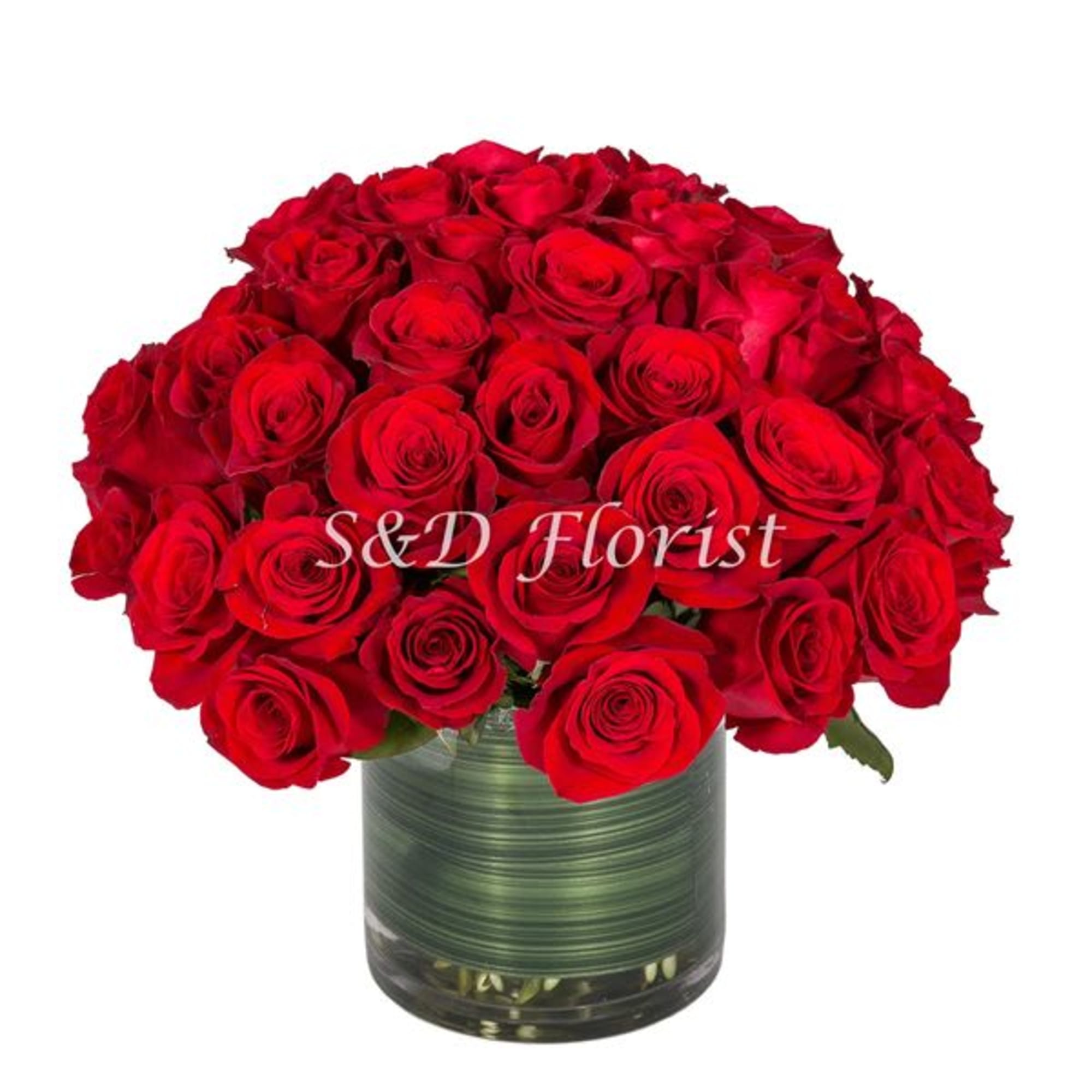 Red roses arranged in a clear glass vase