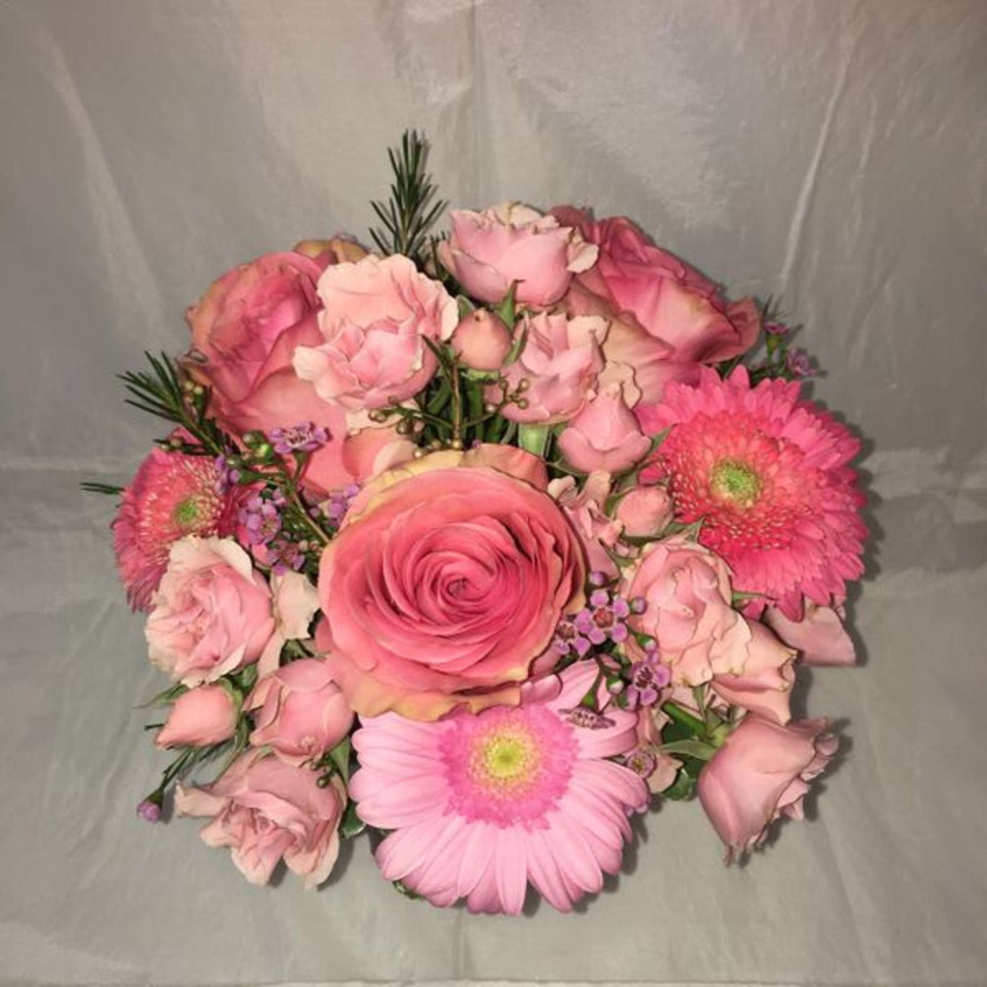 Pink rose and gerbera daisy bouquet with small purple accents