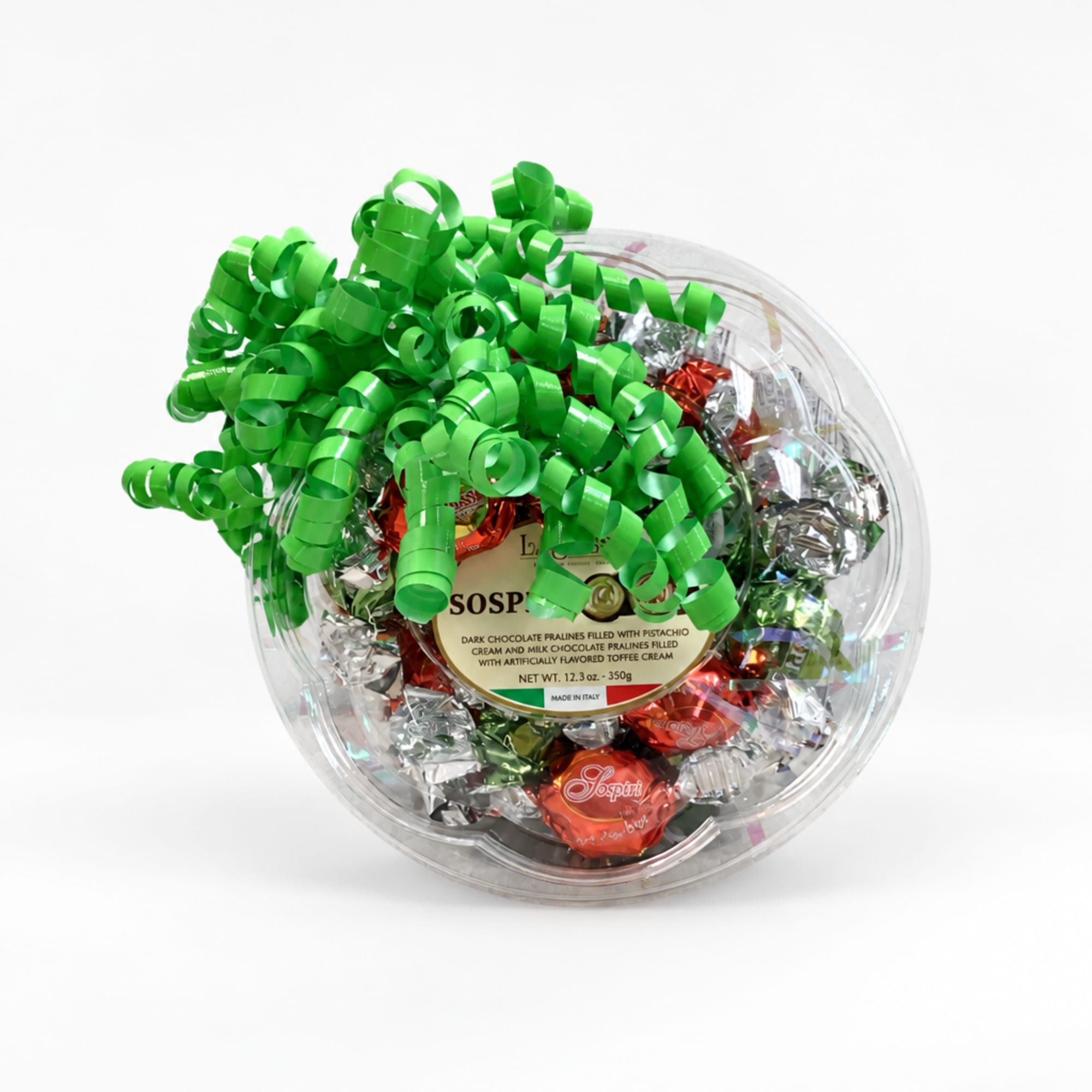 Clear round gift box of assorted chocolates topped with a green curly bow