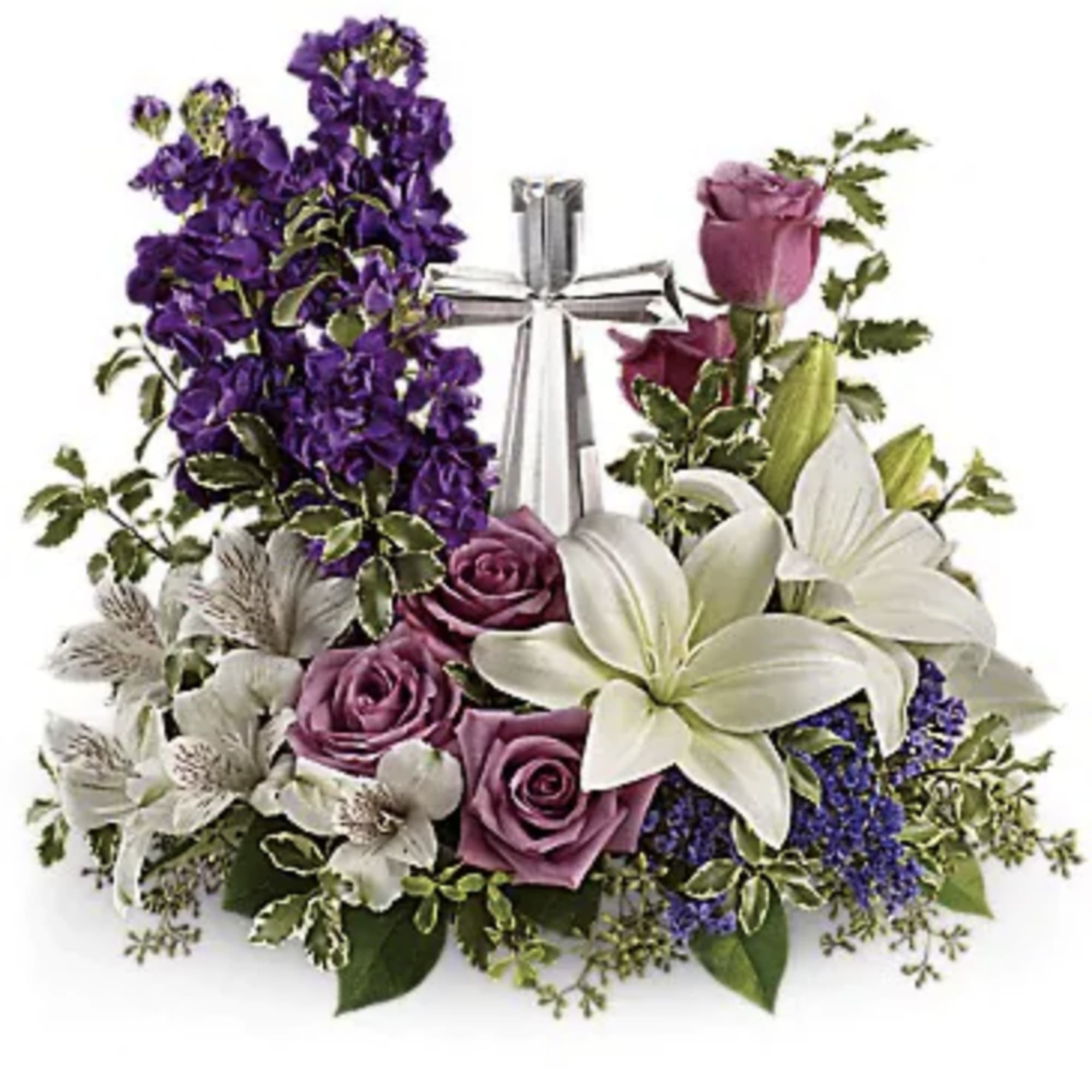 Purple roses and white lilies arranged around a silver cross