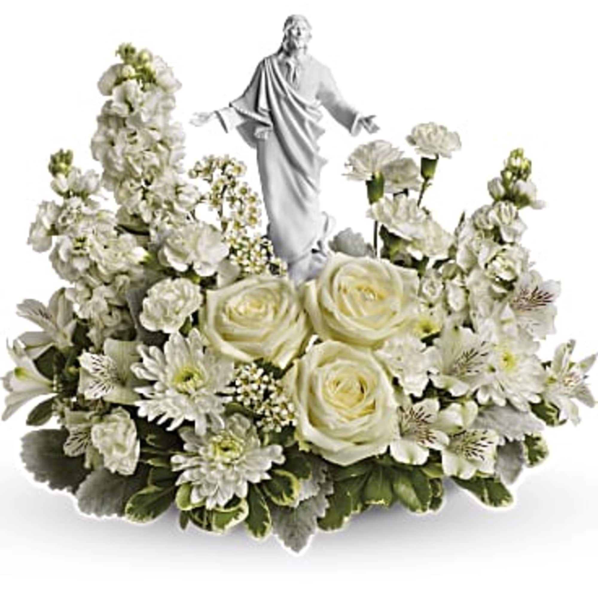 White floral arrangement with a small statue in the center