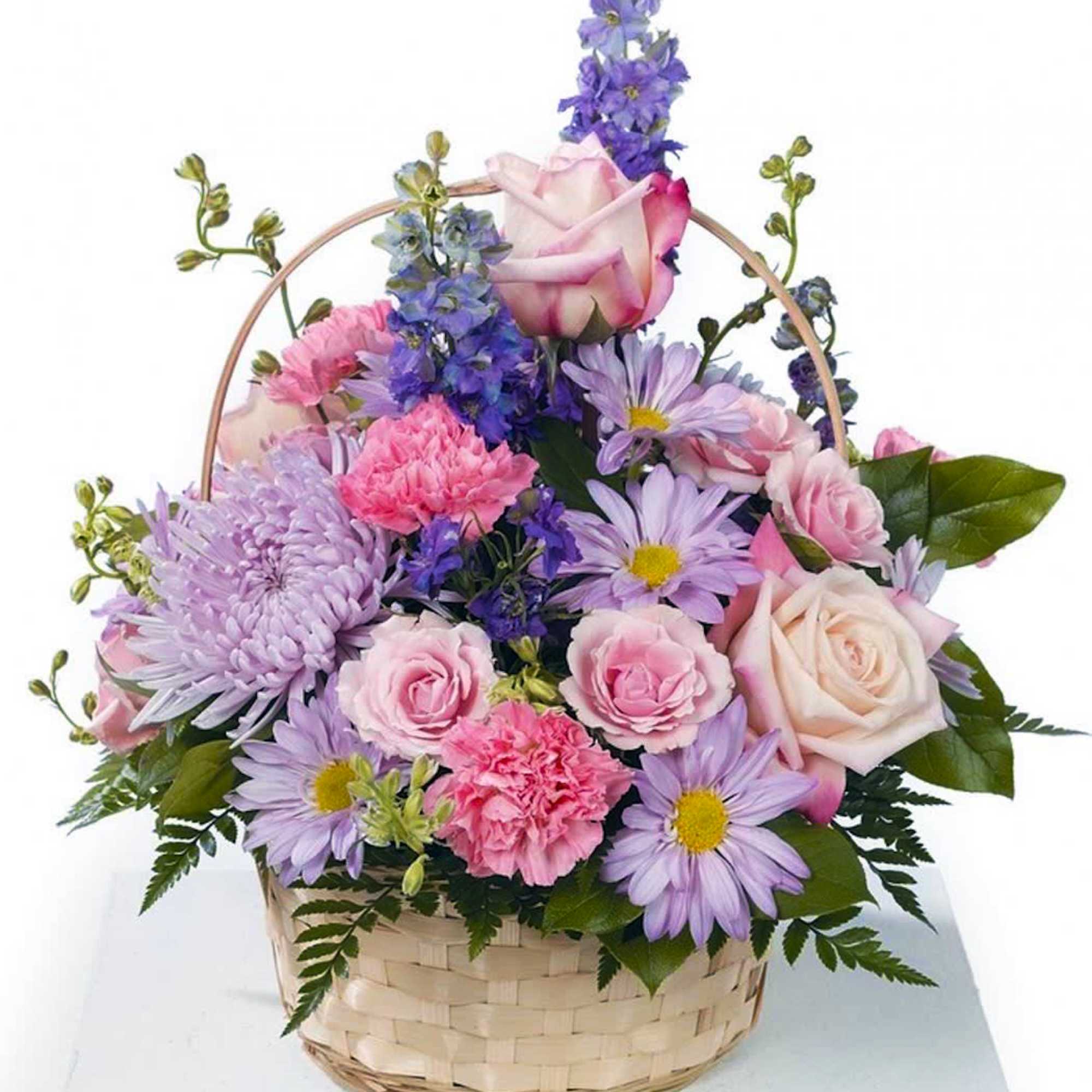 Pastel pink and lavender mixed flower basket with roses, carnations, daisies, and delphinium