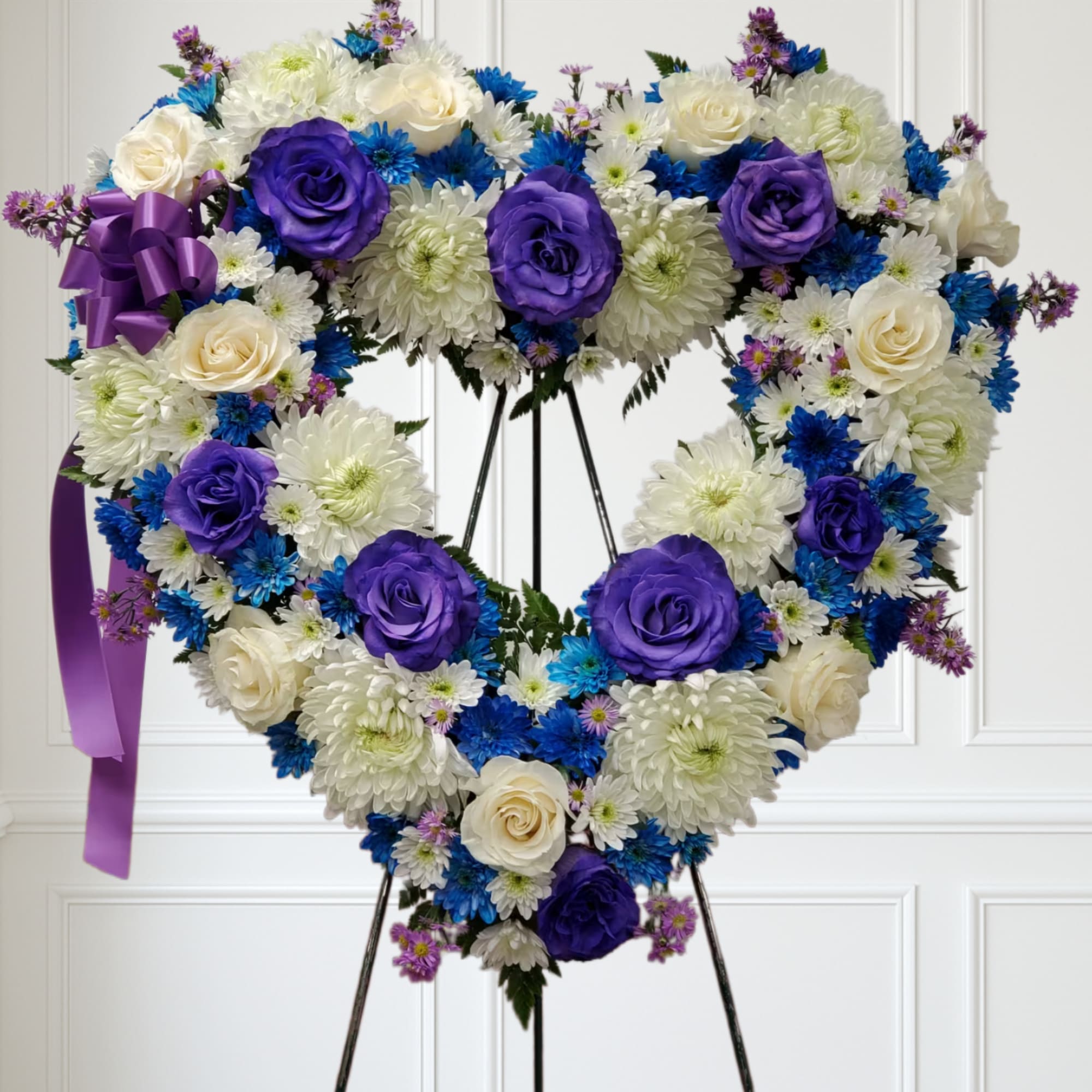Blue flowers with deep purple roses and white flowers.