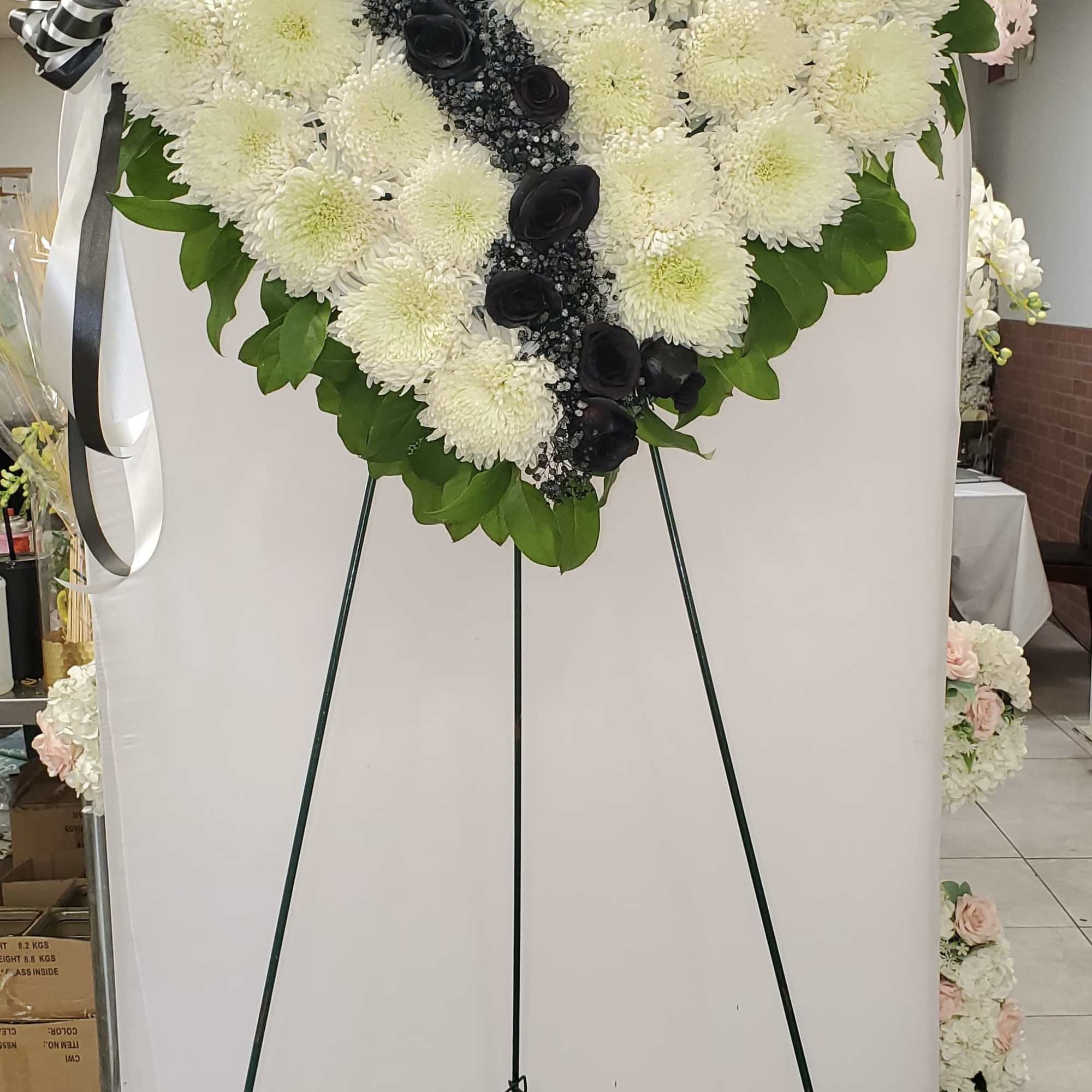 Heart-shaped floral standing spray with white chrysanthemums and black roses