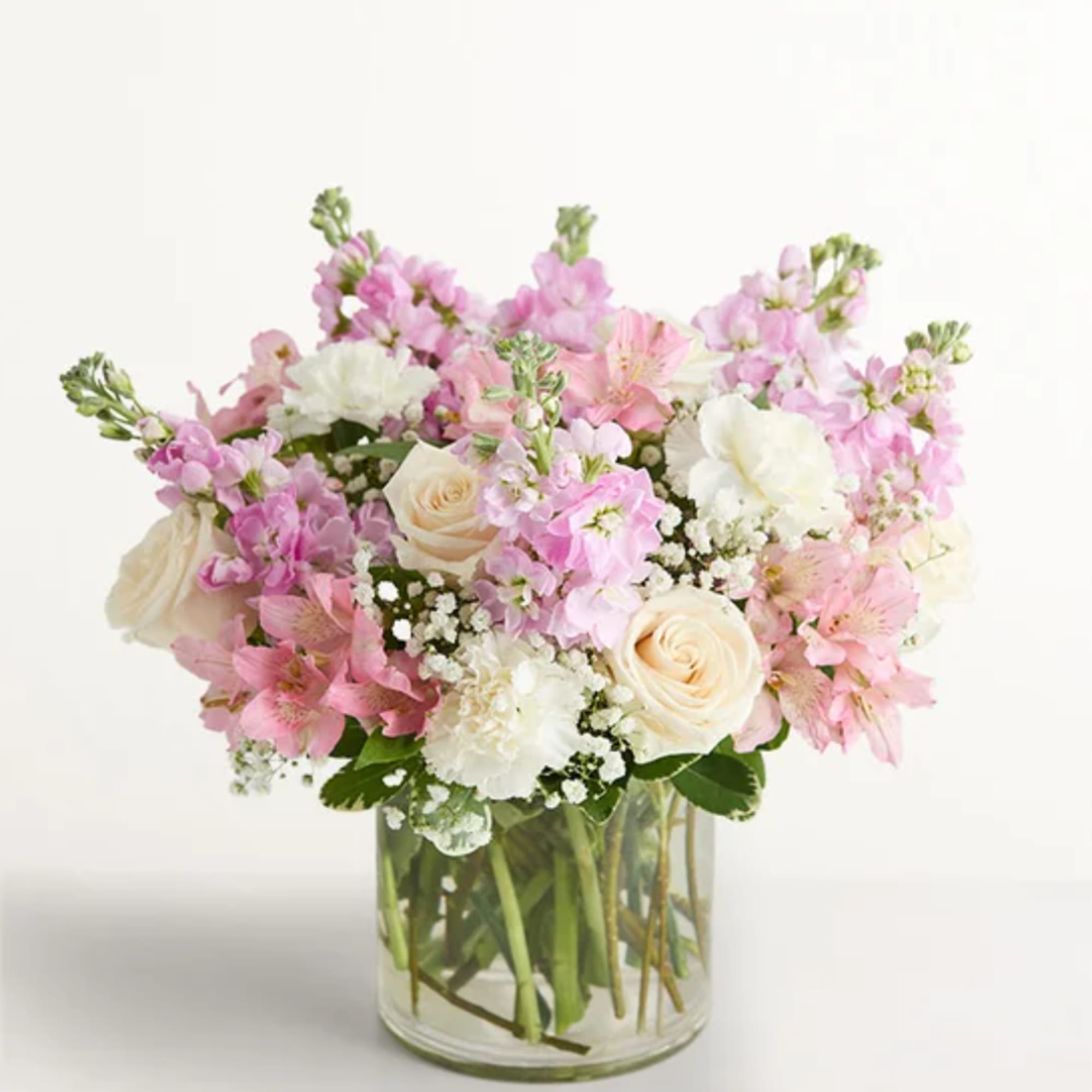 Pink and white mixed bouquet in a clear glass vase
