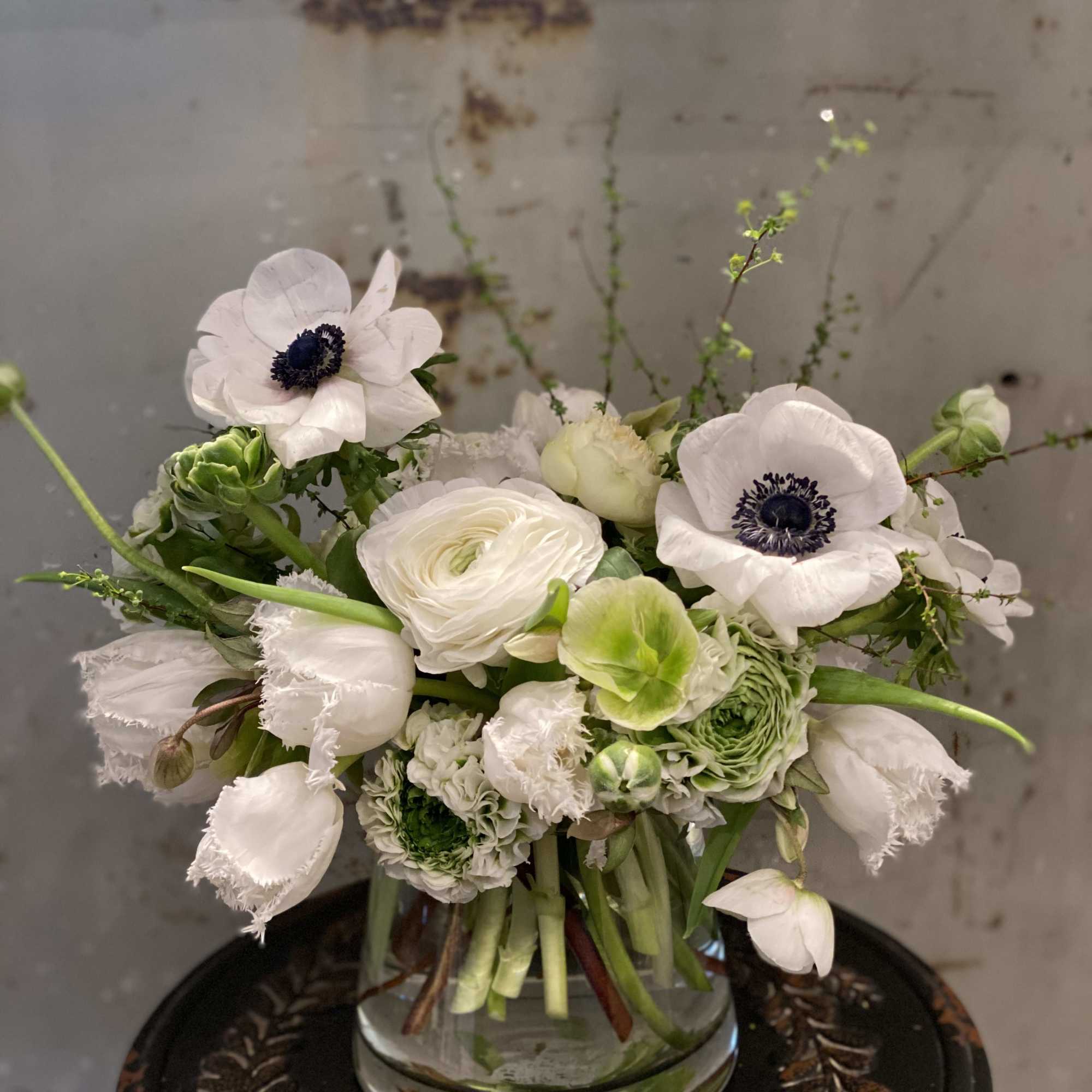 White and green floral arrangement in a clear glass vase, photo 2 of 2