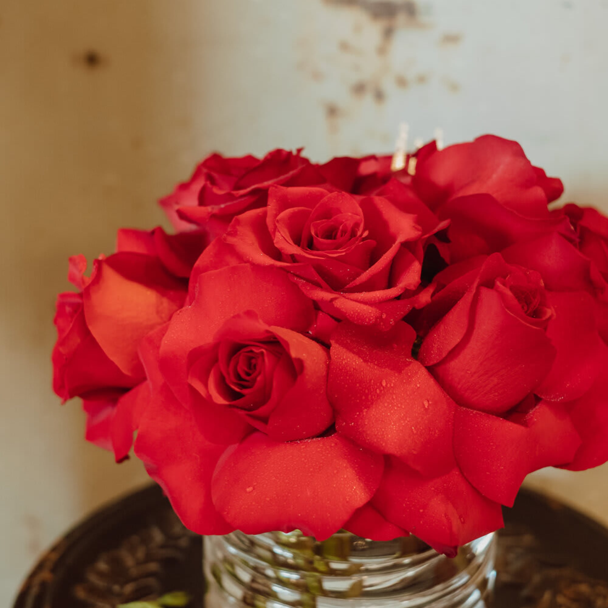 Red roses arranged in a clear glass vase, photo 3 of 3
