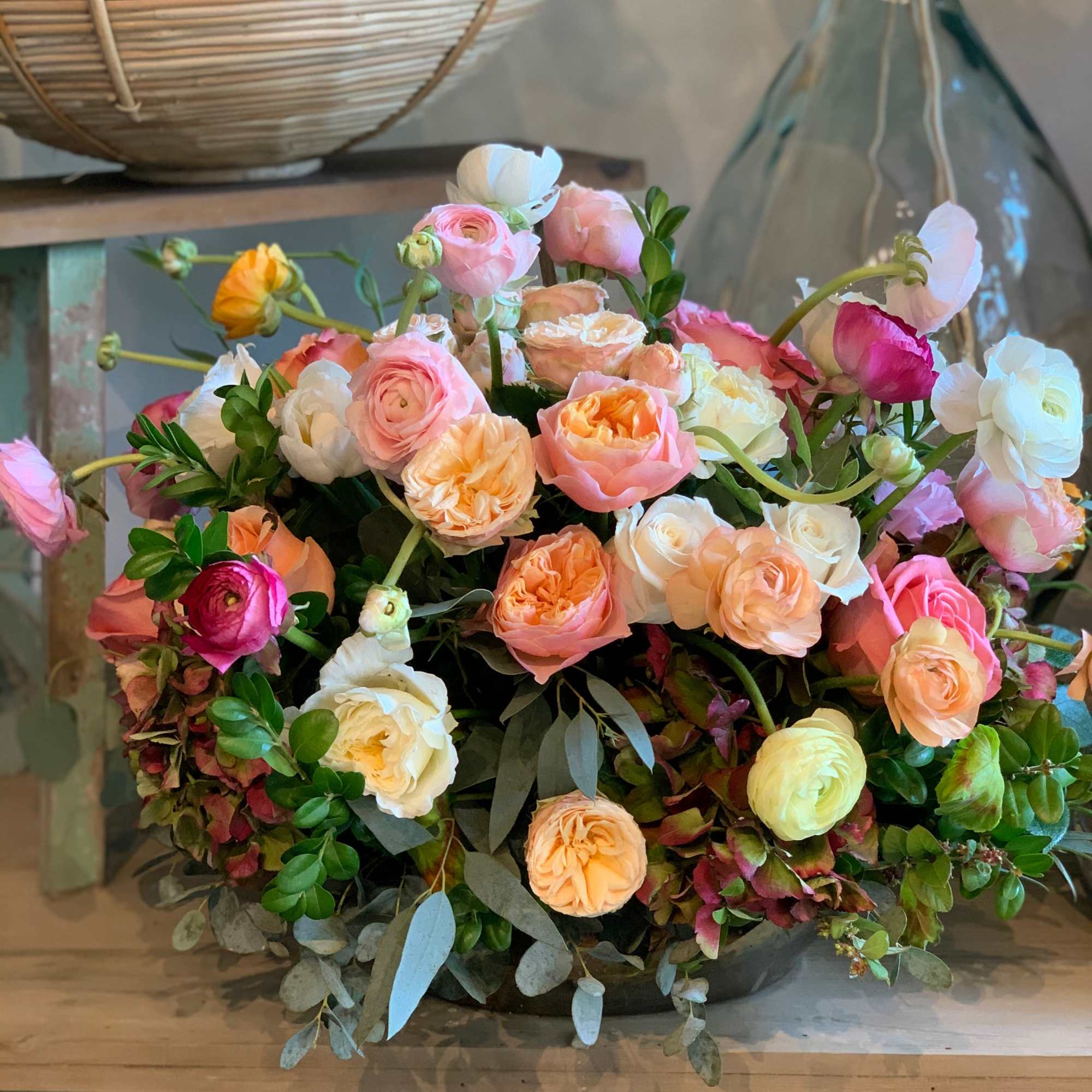 Mixed bouquet of pink, peach, white, and yellow ranunculus