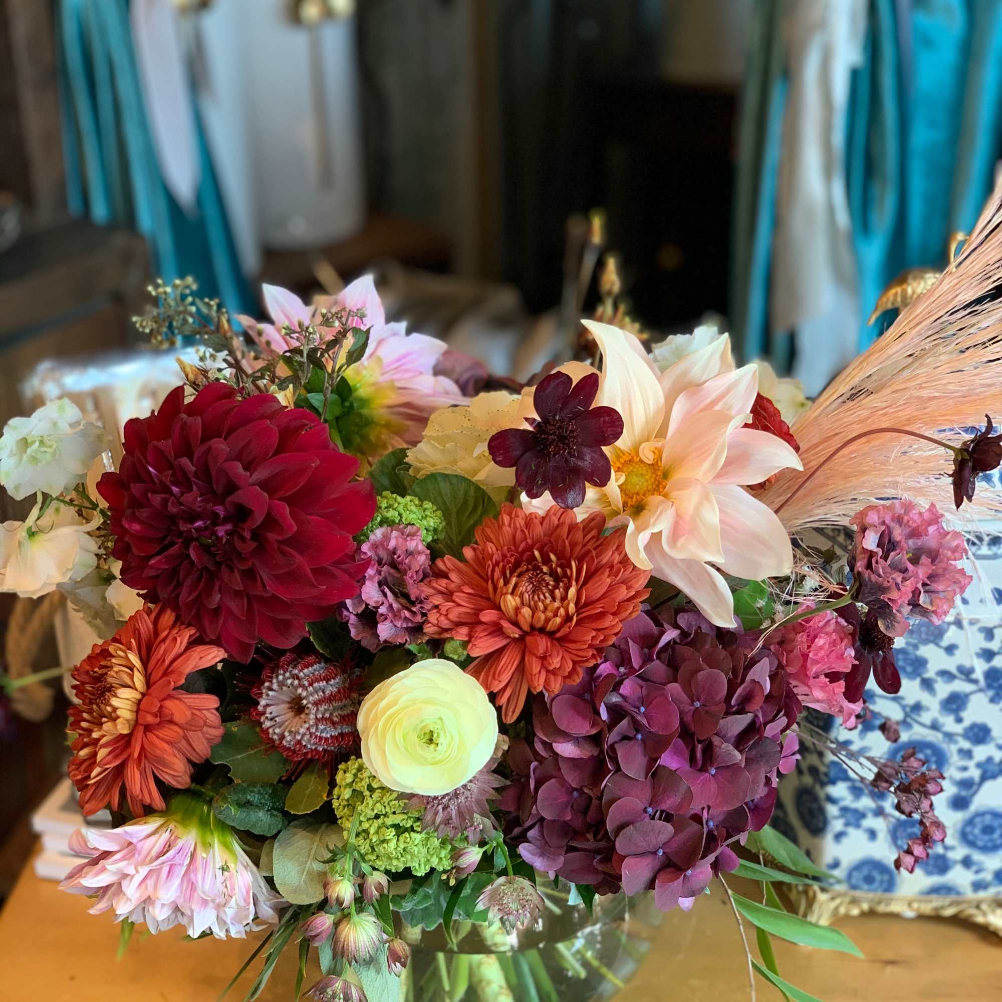 Mixed bouquet in a glass vase with dahlias, hydrangea, and lilies