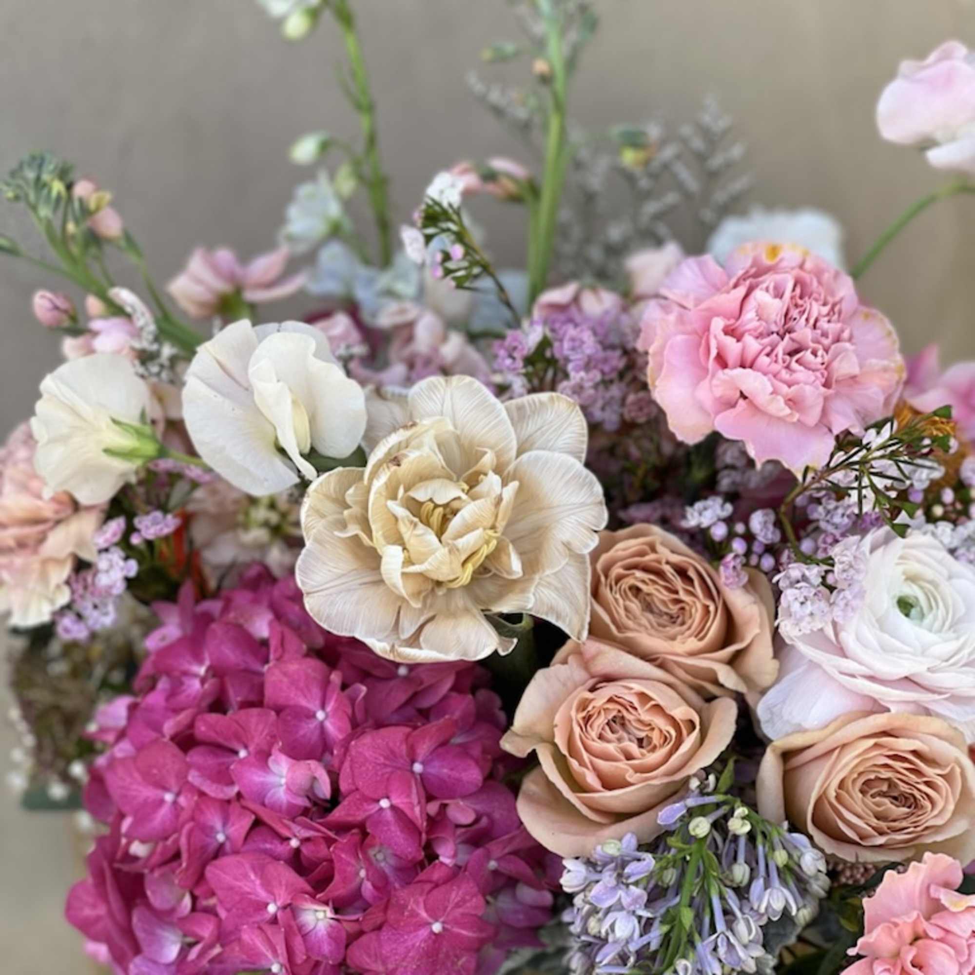 Mixed bouquet with pink hydrangea, roses, and pale blooms