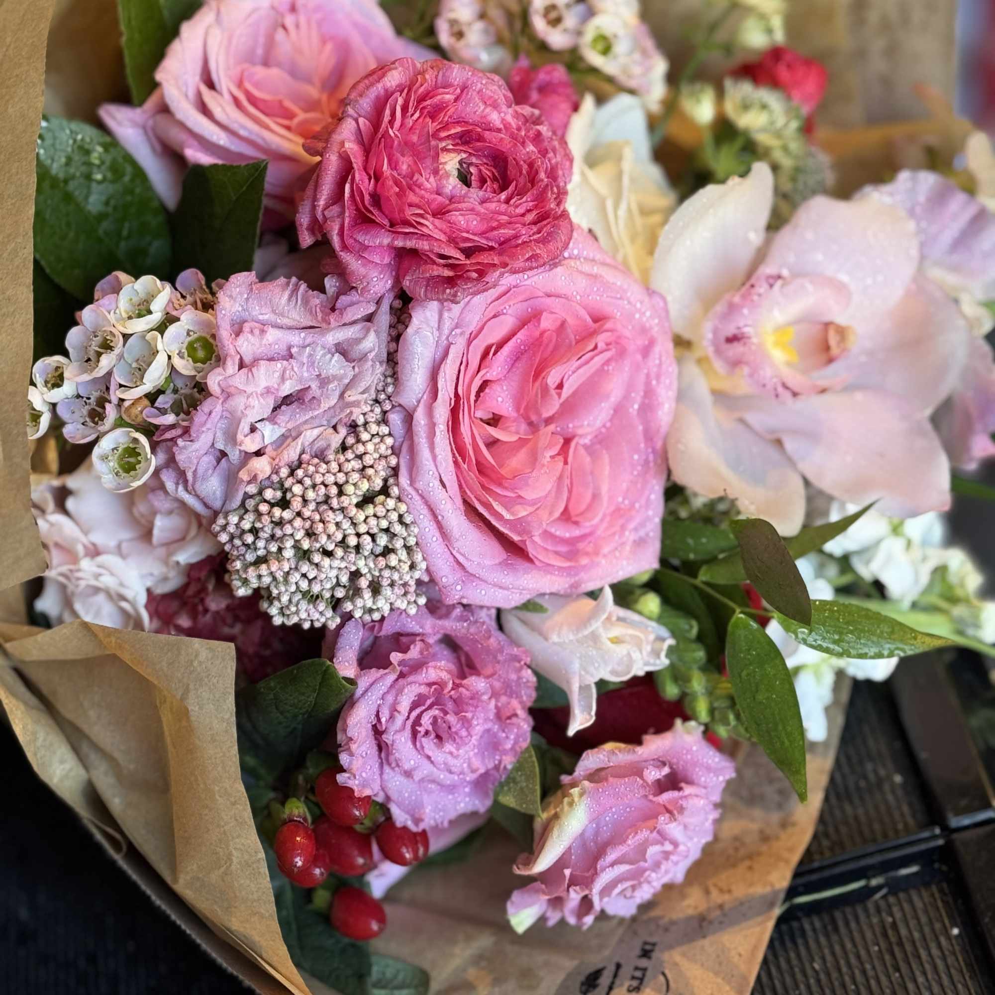 Pink and white mixed bouquet wrapped in brown paper
