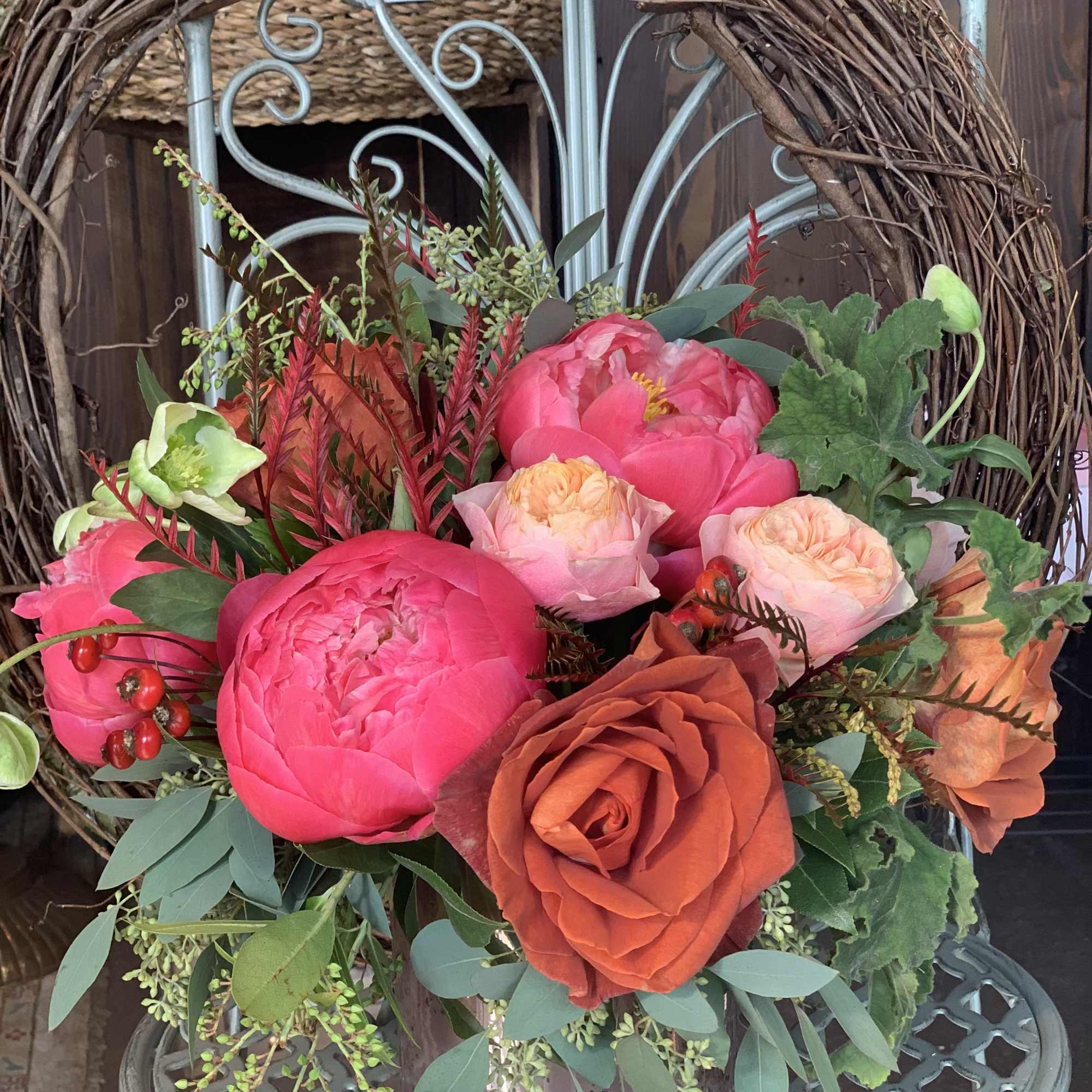 Bouquet of pink and orange roses in a glass vase