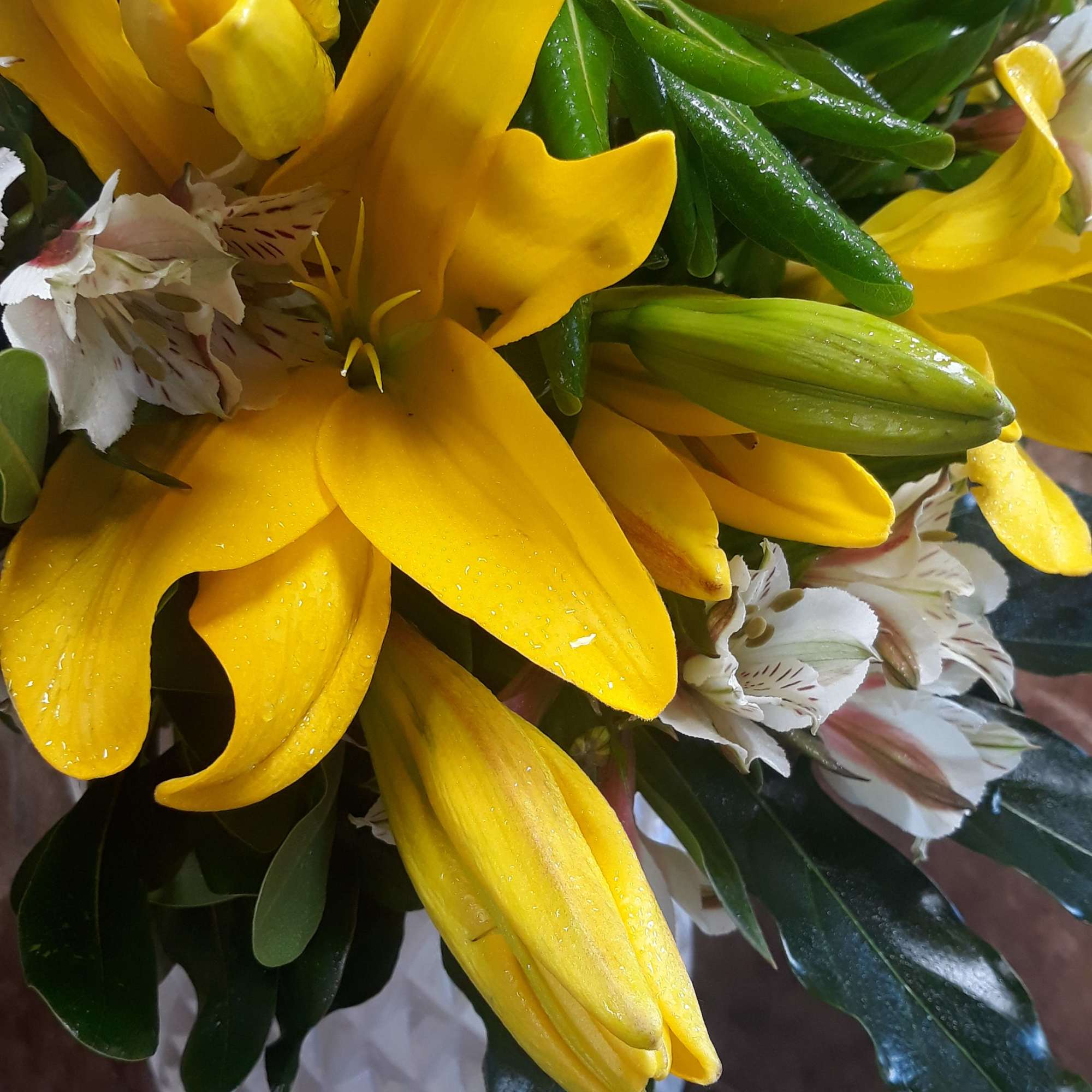 Bouquet of yellow lilies with white striped alstroemeria
