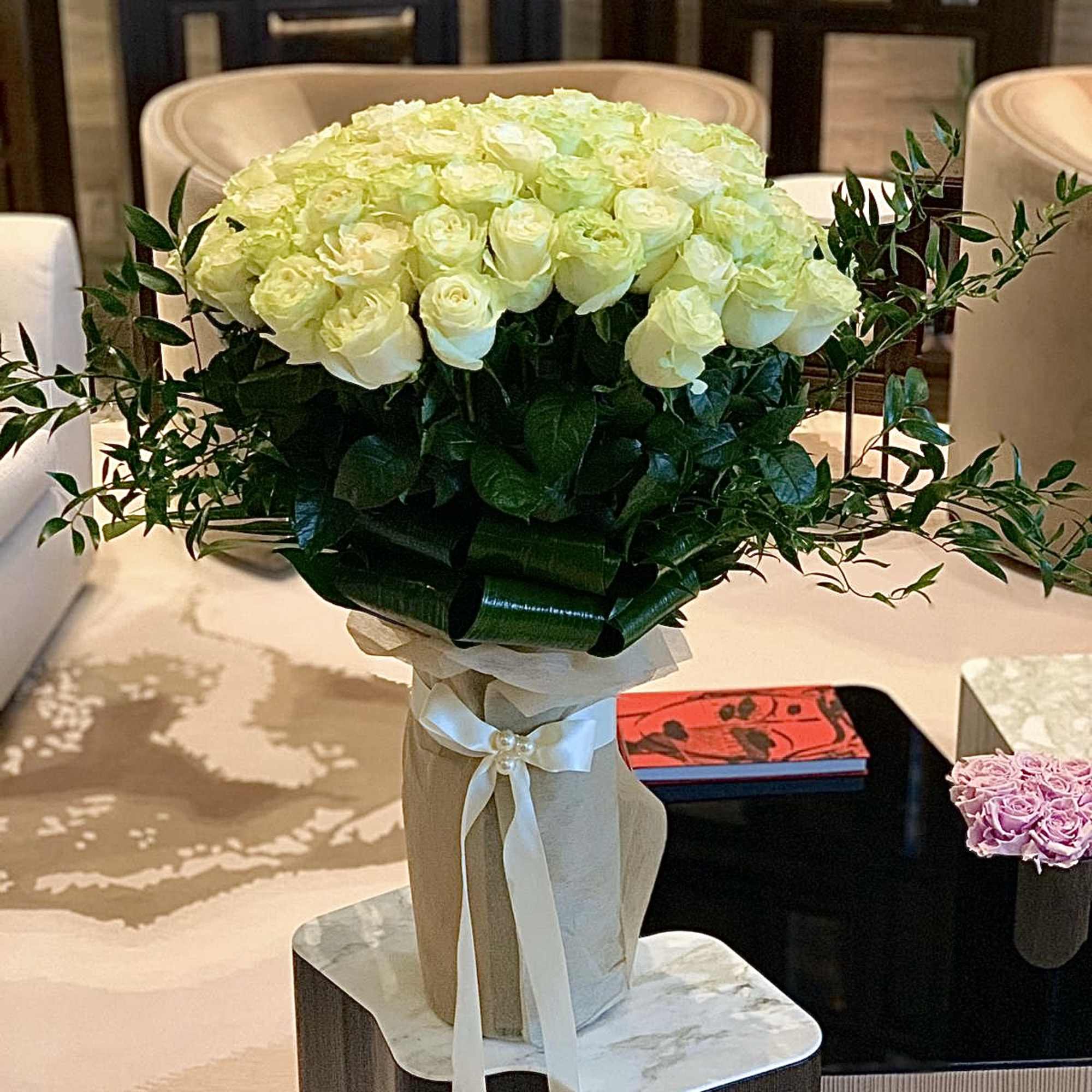 Large bouquet of white roses with ribbon wrap