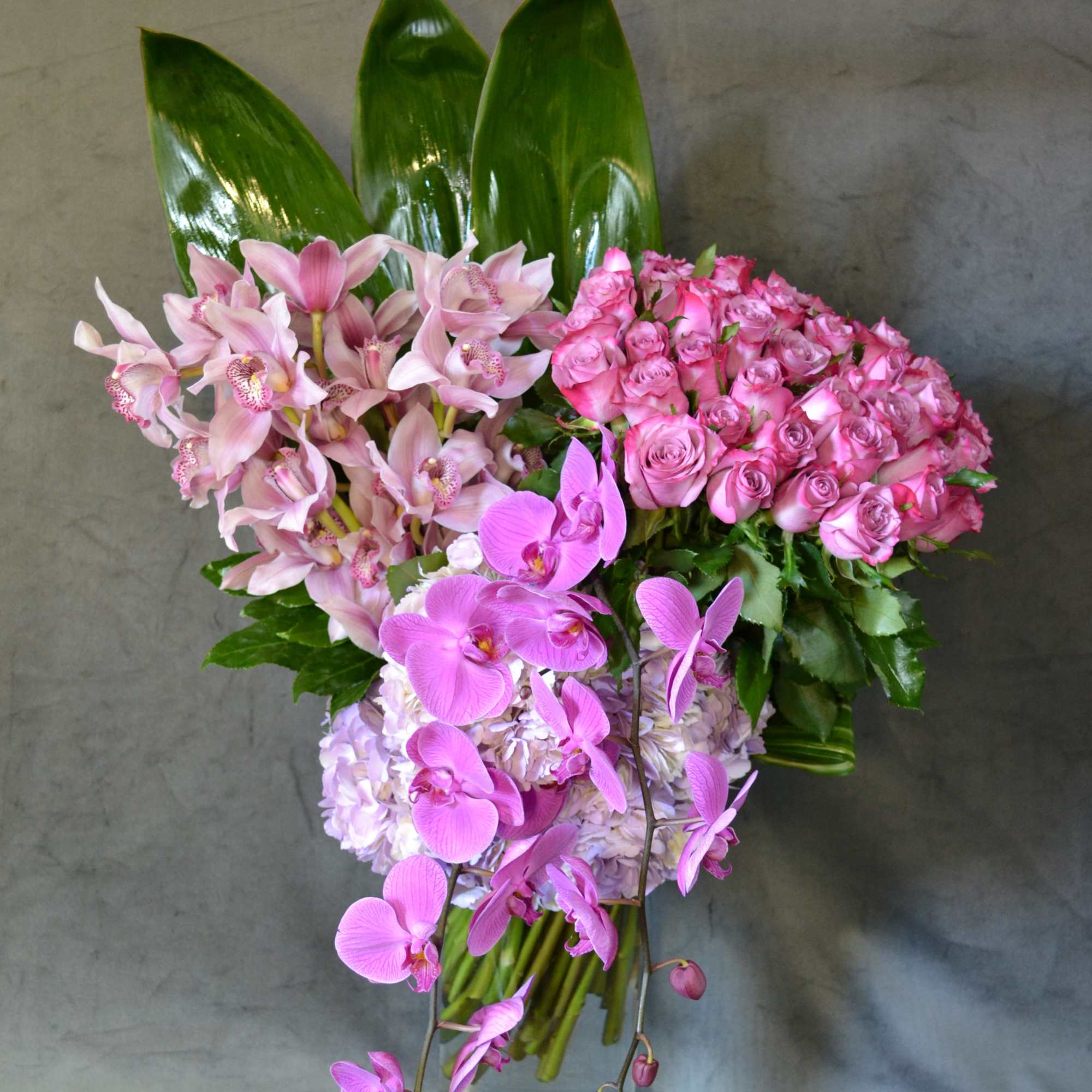 Roses, Hydrangeas, Cymbidium Orchids, Phalaenopsis Orchids. Perfectly combine and arranged in a