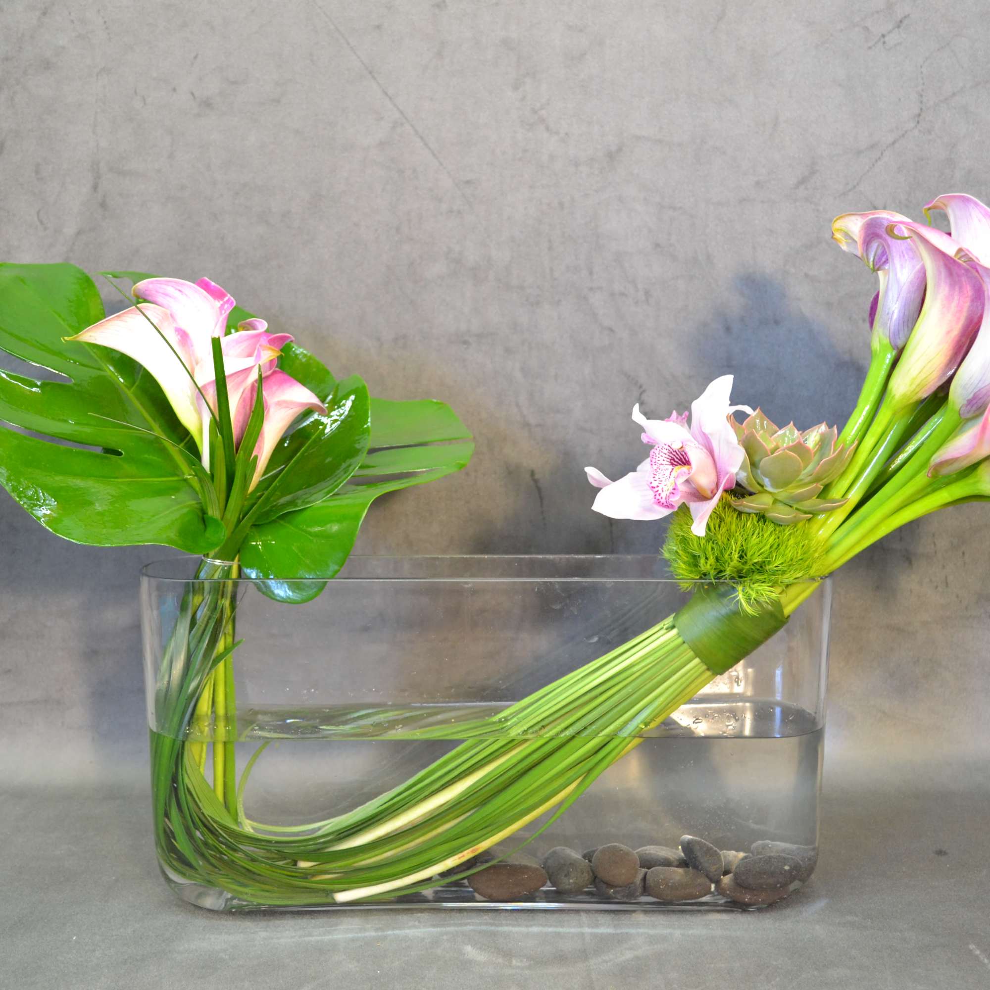 Calla lilies and a touch of cymbidium orchids and succulent.