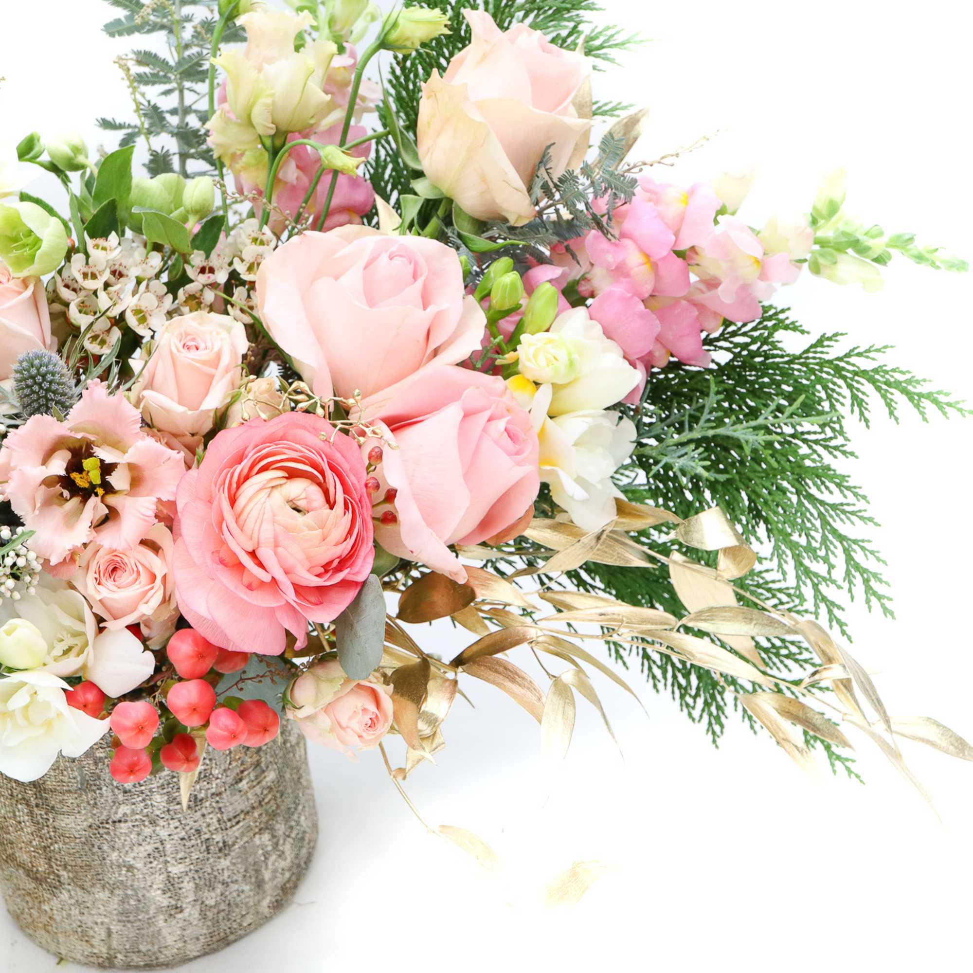 Pink and white flower arrangement in a textured vase