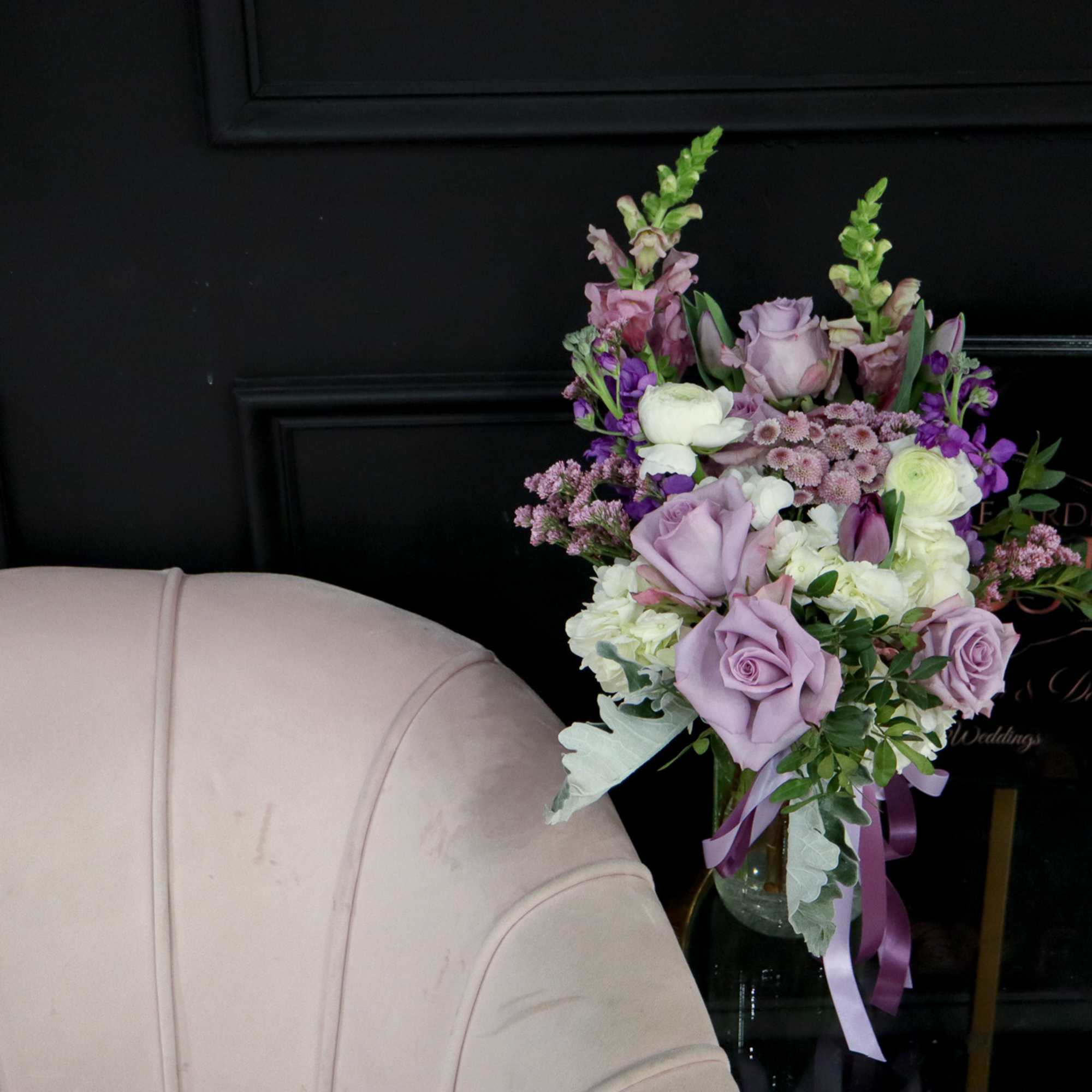 Lavender and white floral arrangement in a glass vase