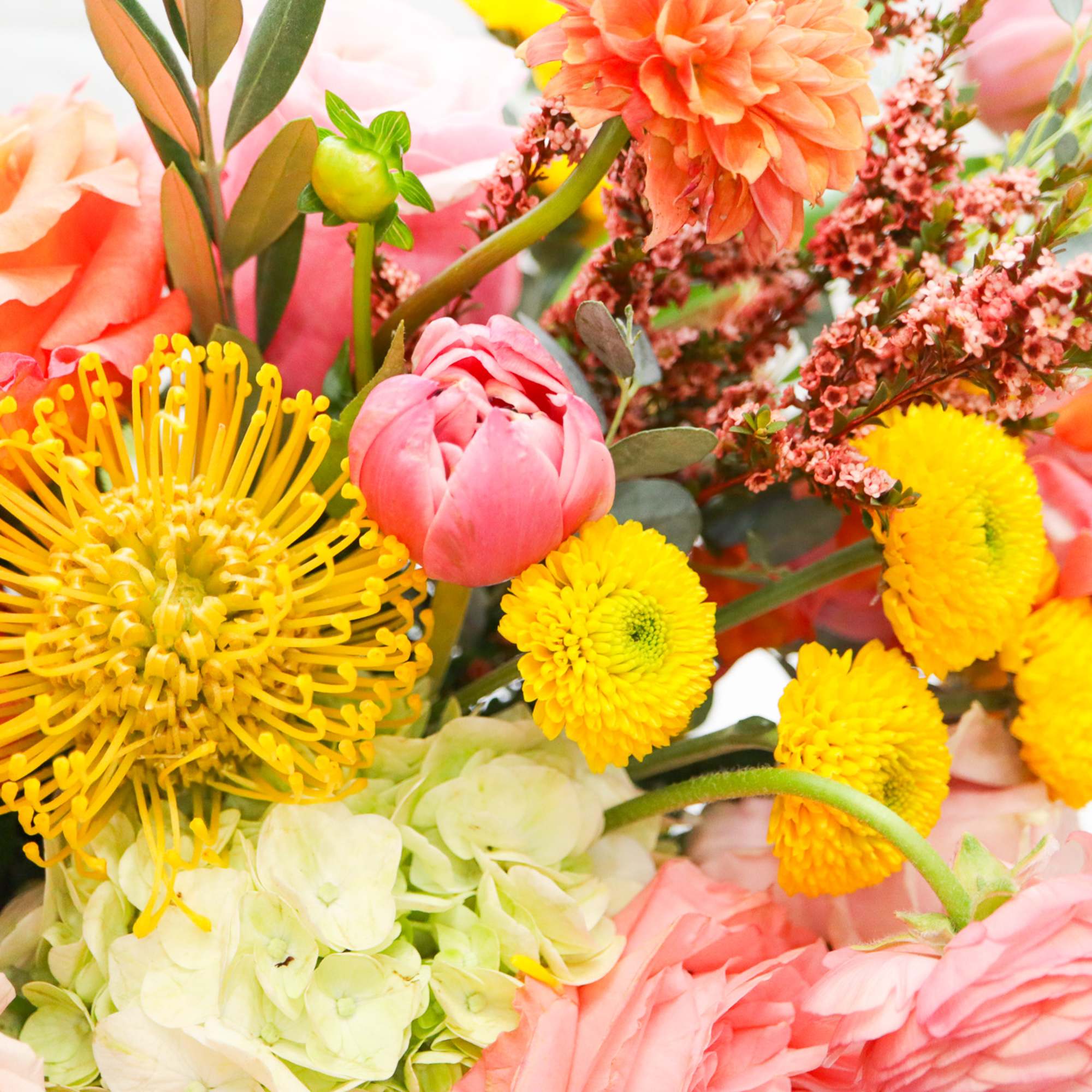 Close-up bouquet of pink, peach, and yellow flowers