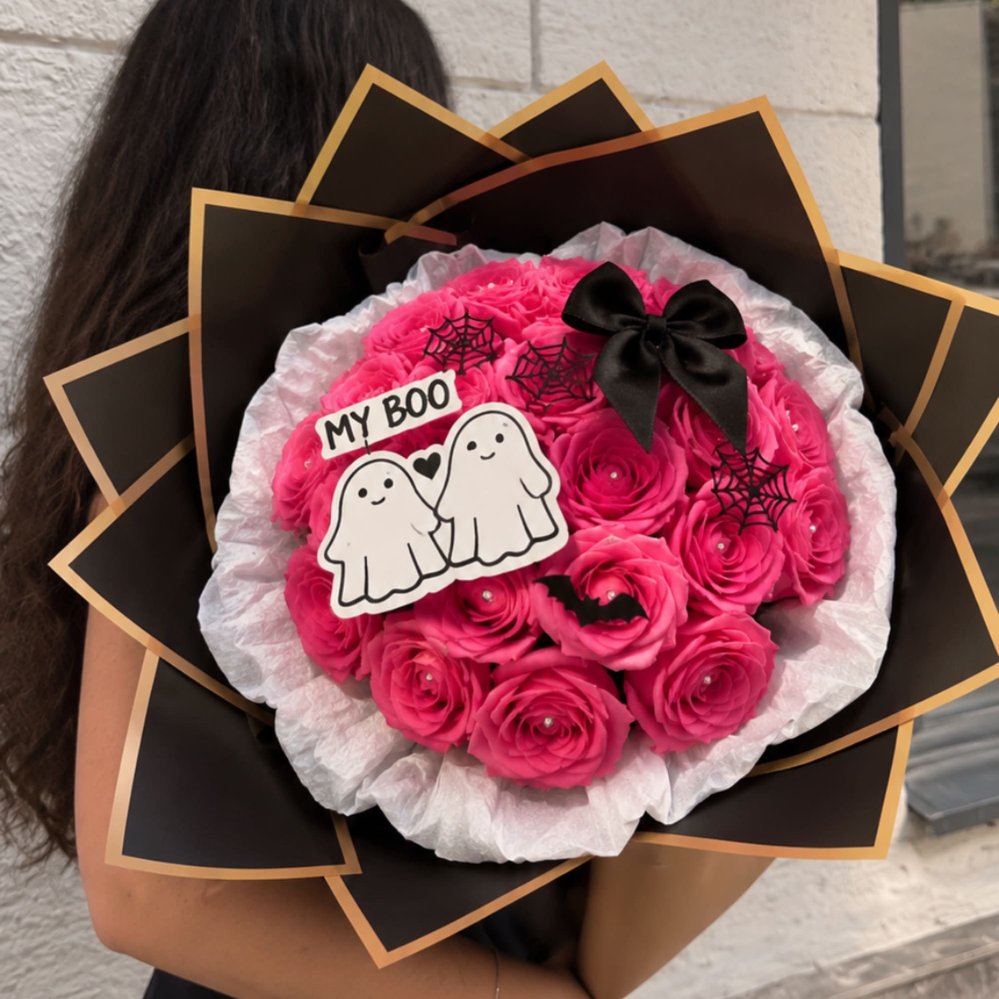 Pink rose bouquet with a black bow and Halloween ghost topper