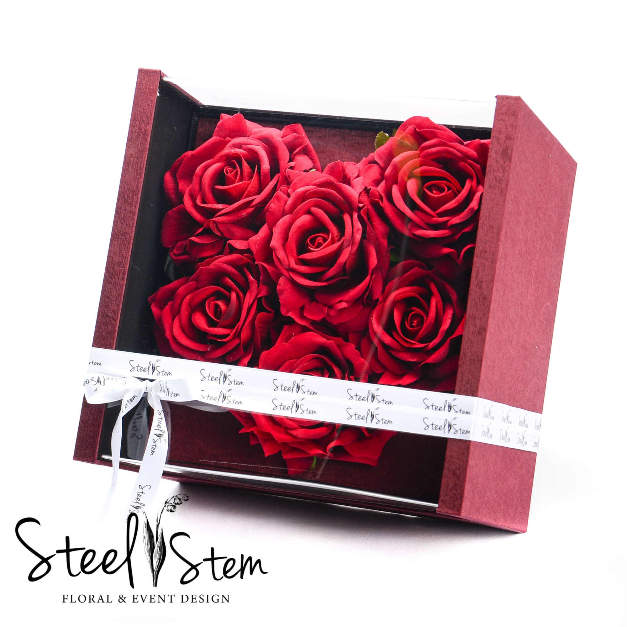 A large acrylic and cardboard box with a heart shaped gift inside