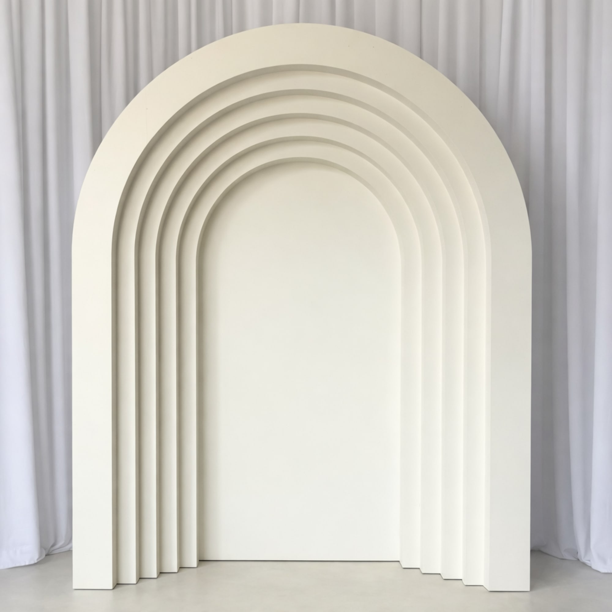 A sculptural layered backdrop designed for elevated celebrations. Featuring clean architectural lines