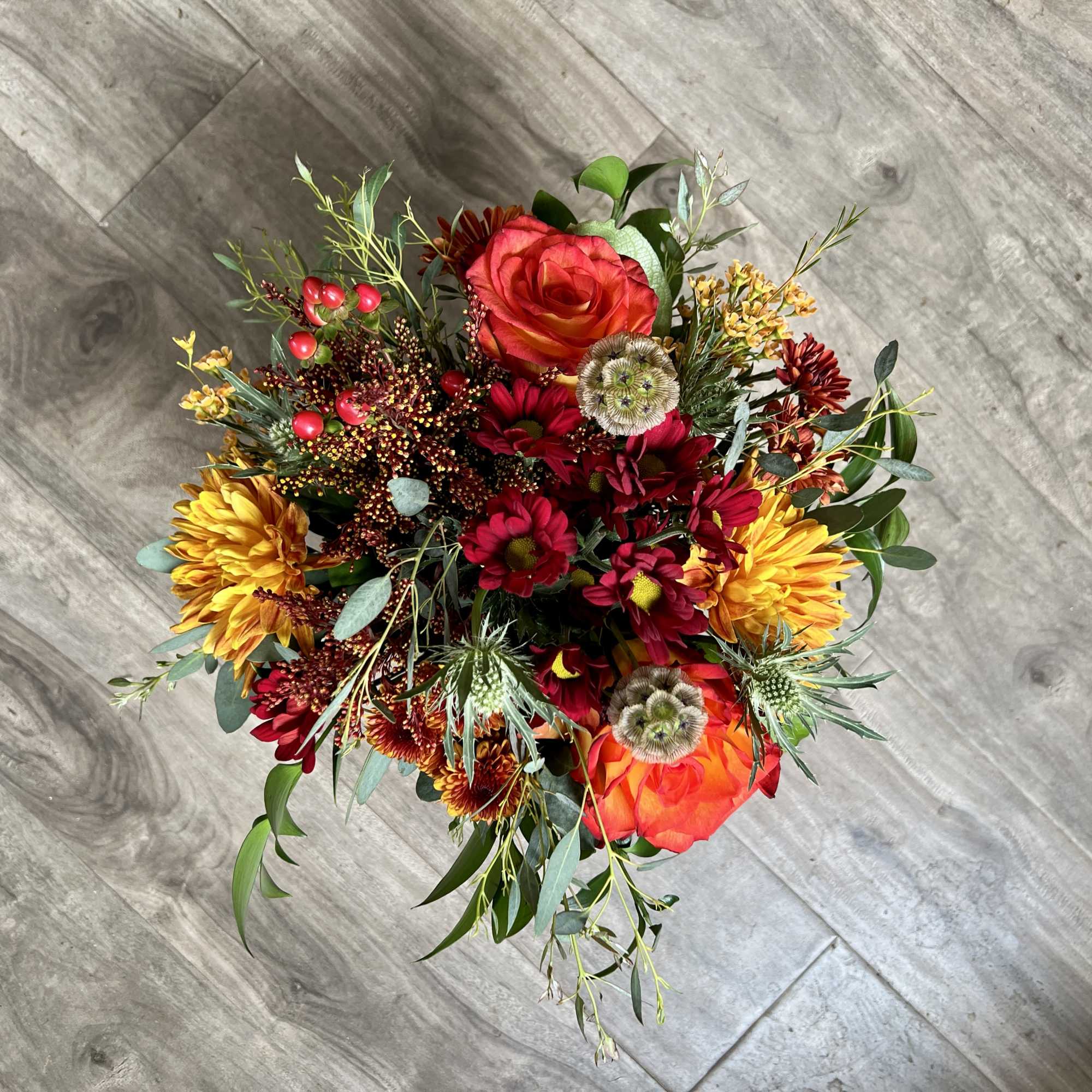 Colorful bouquet with red and orange roses and yellow chrysanthemums