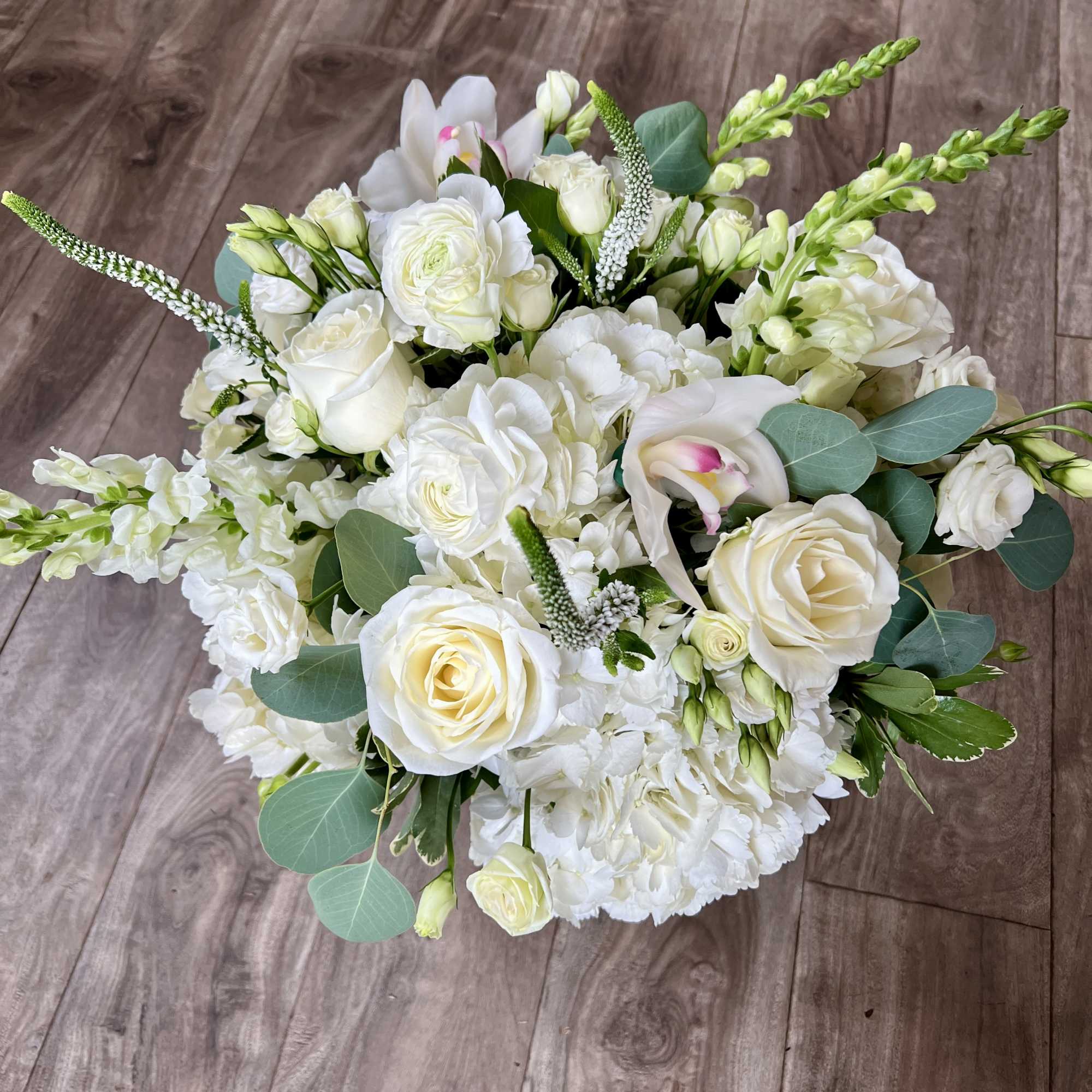 A lush cluster of white hydrangeas and garden roses creates the first, photo 2 of 2