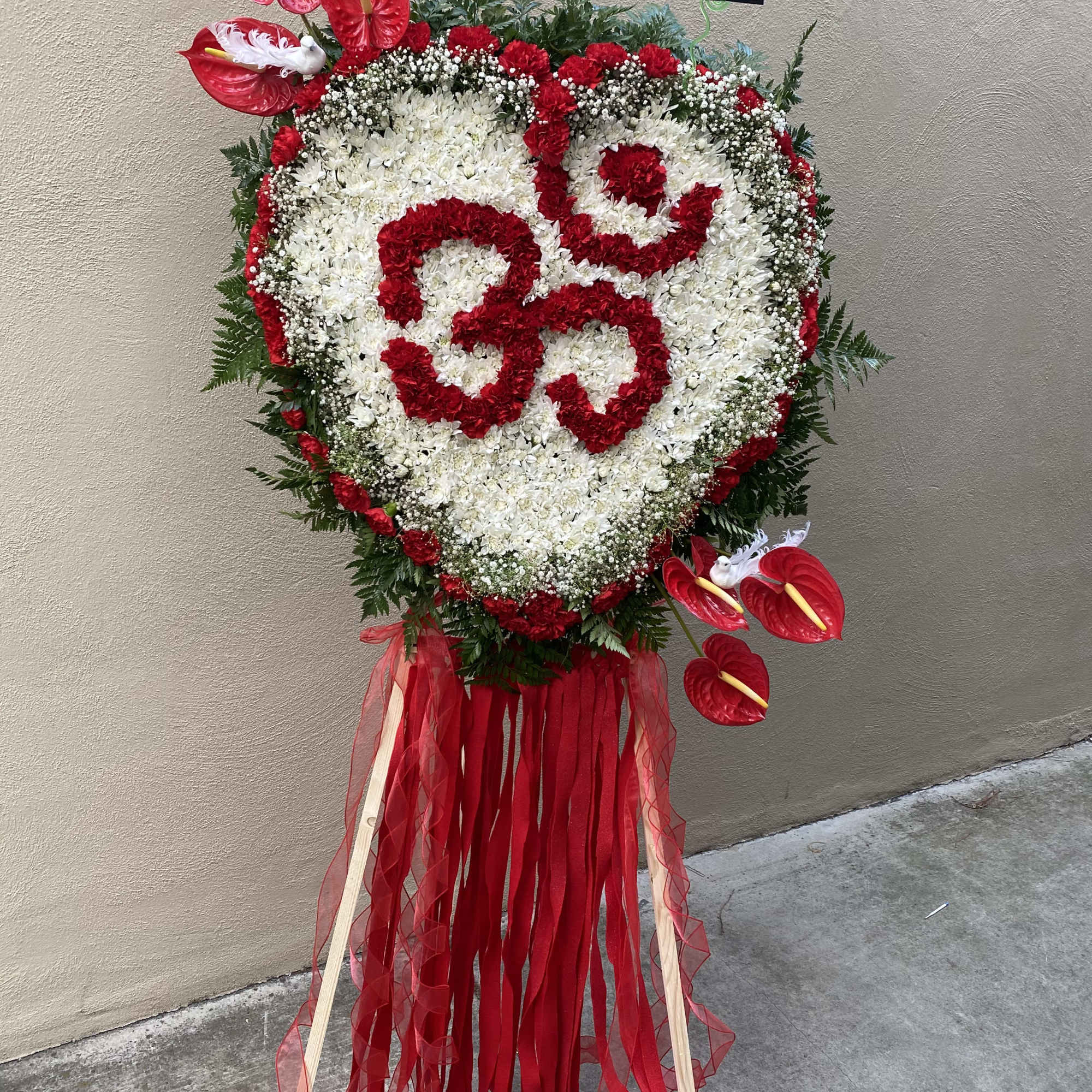 Heart-shaped floral standing spray with red and white flowers and ribbon streamers, photo 2 of 8