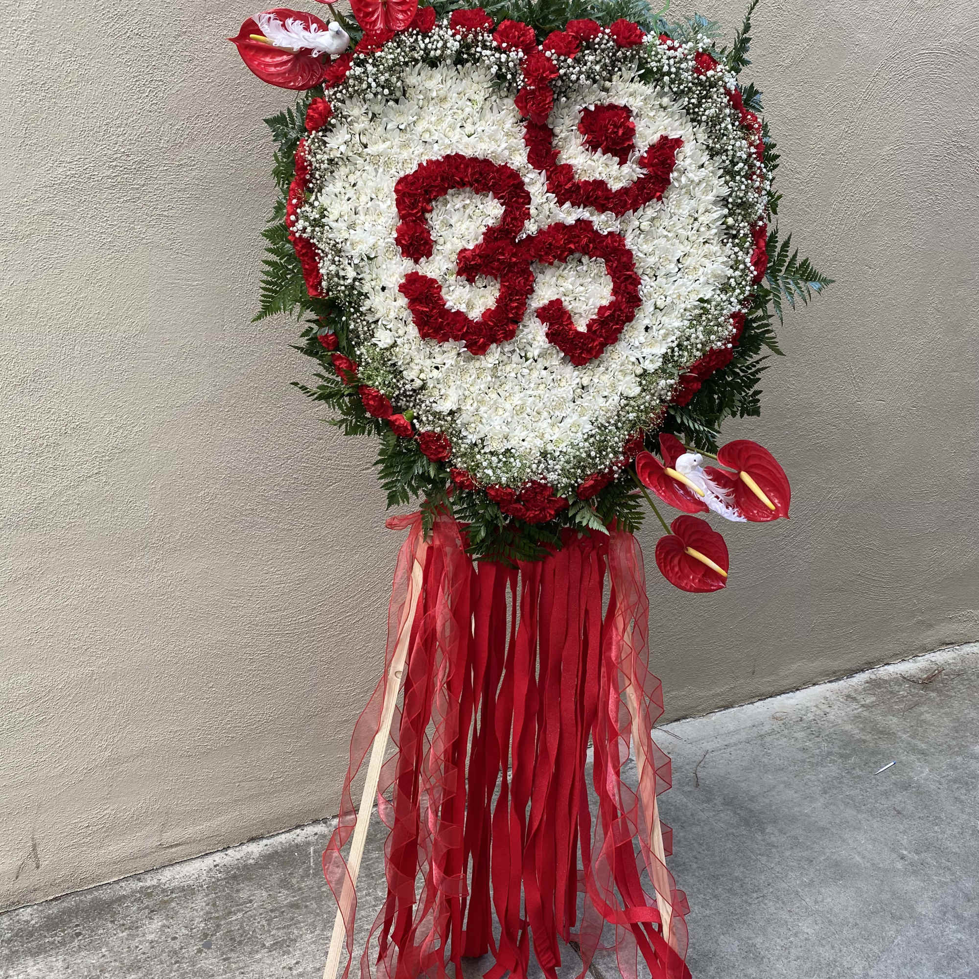 Heart-shaped floral standing spray with red and white flowers and ribbon streamers, photo 8 of 8