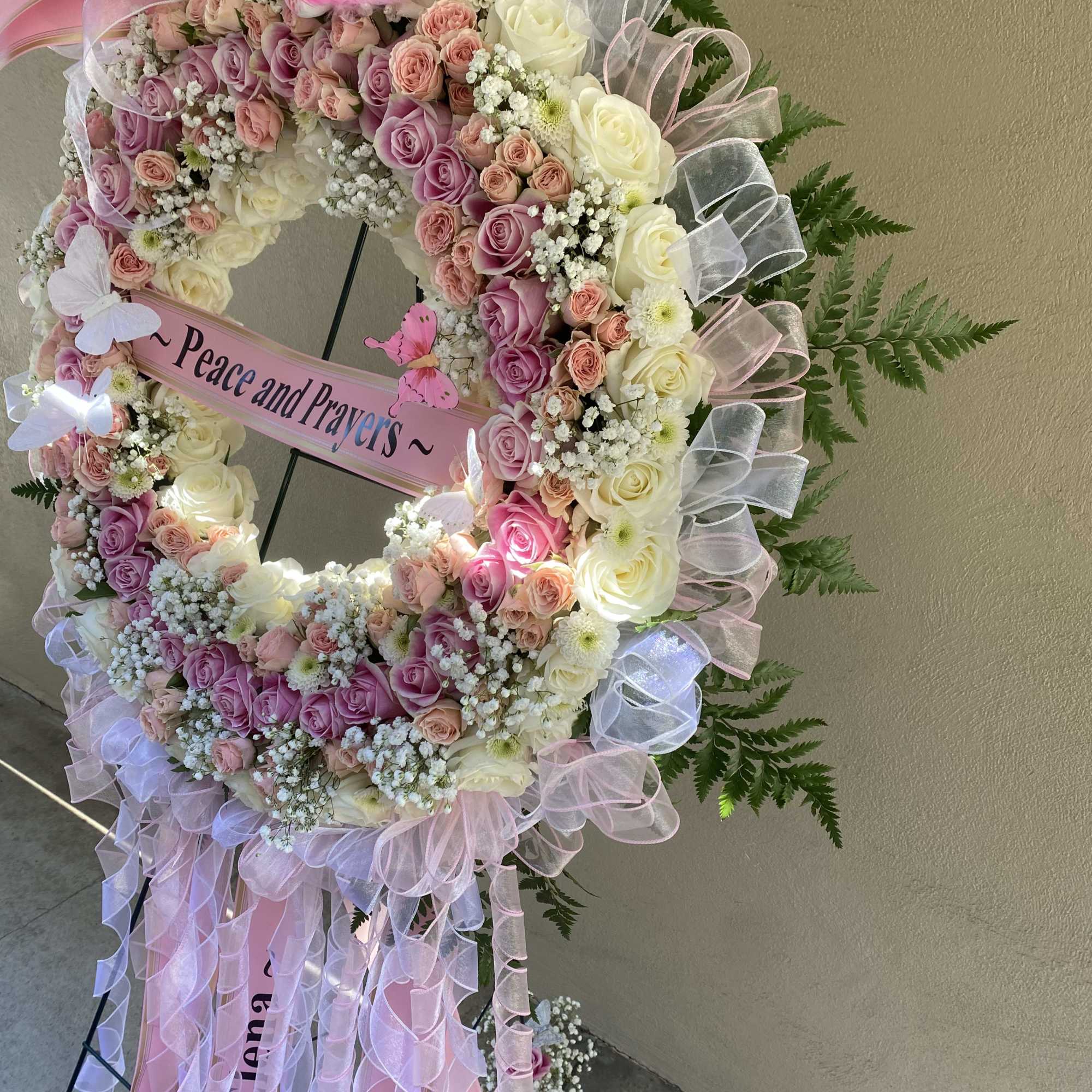 Pink and white rose wreath with a "Peace and Prayers" ribbon, photo 3 of 21
