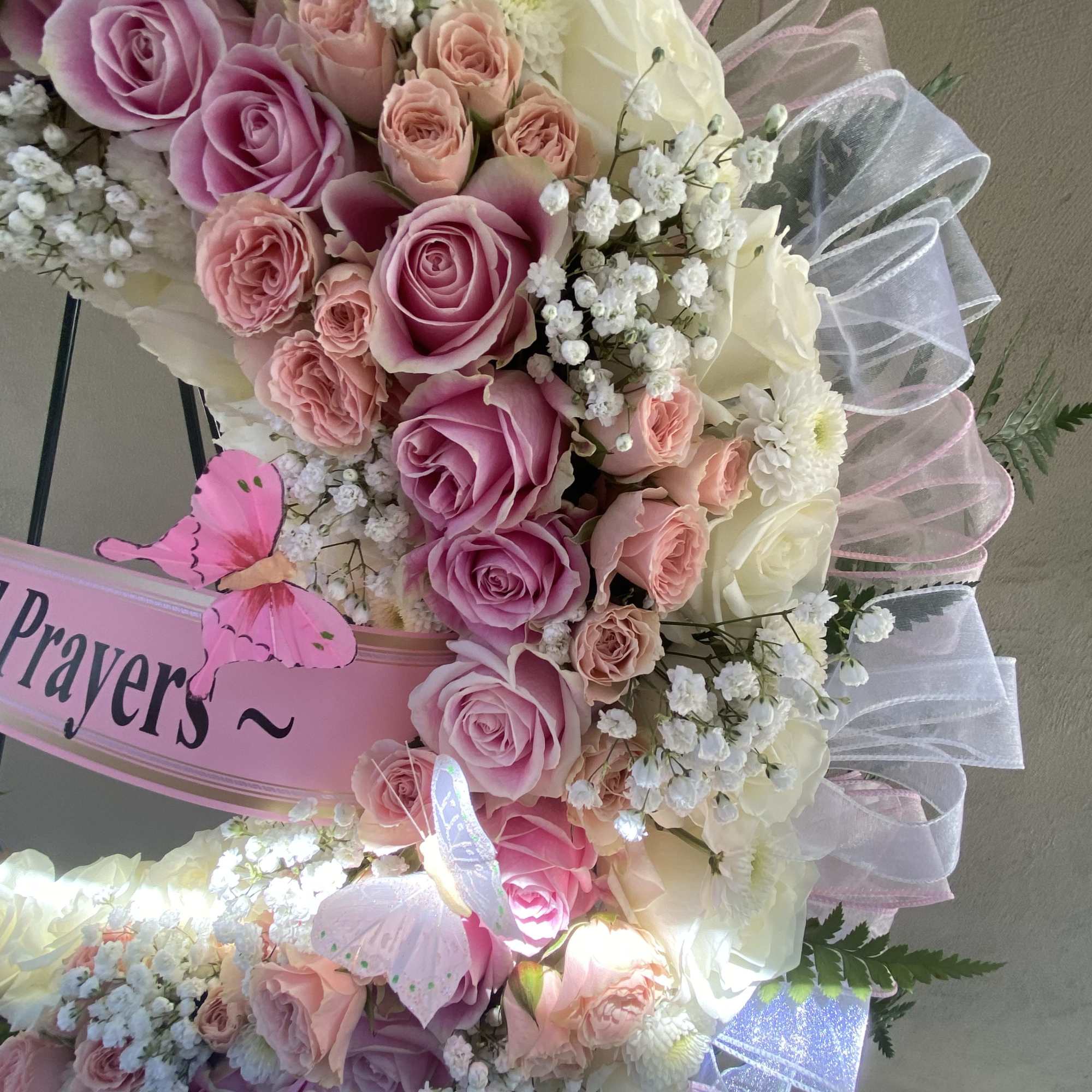 Pink and white rose bouquet with baby’s breath and ribbon