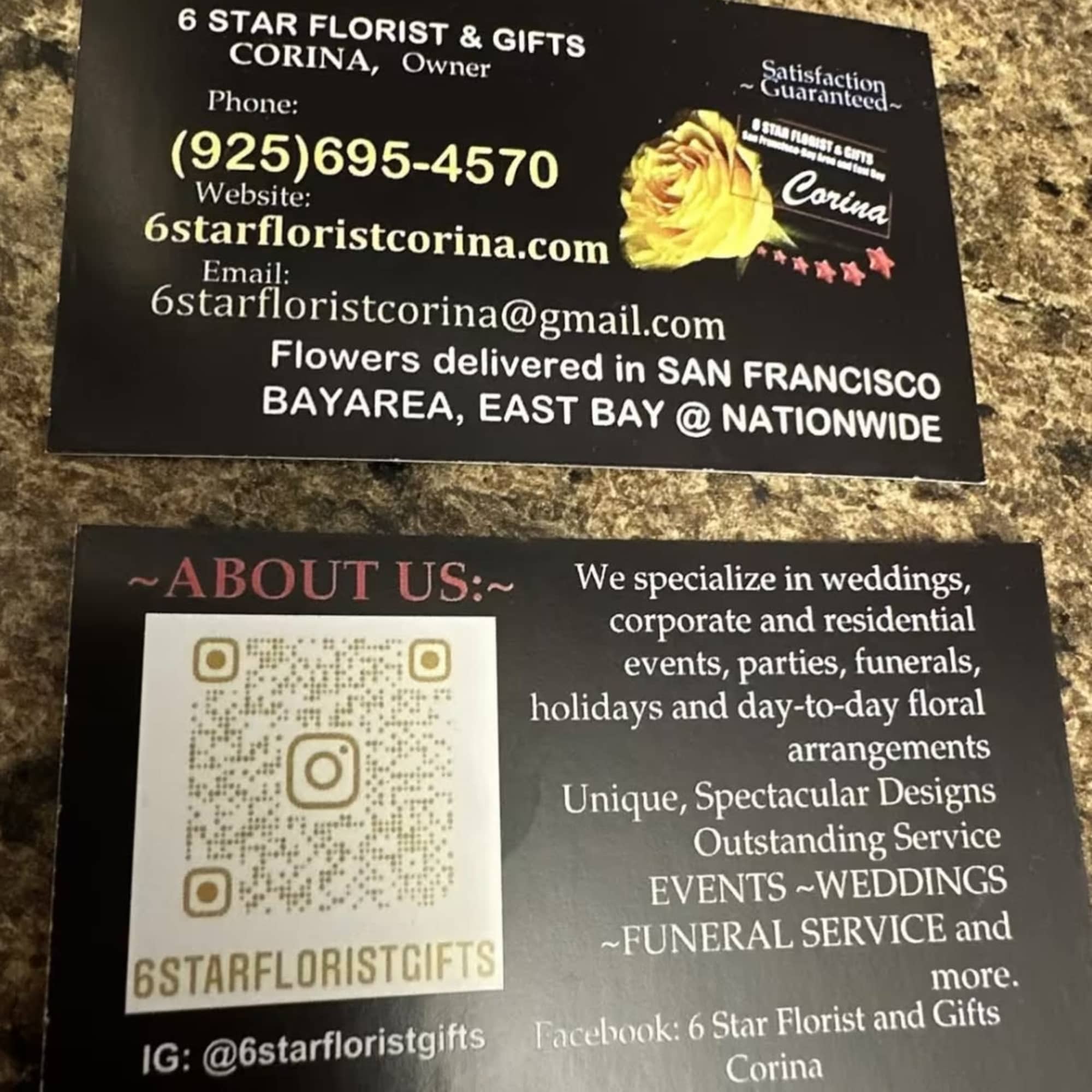 Two florist business cards on a countertop, one with a yellow rose graphic.
