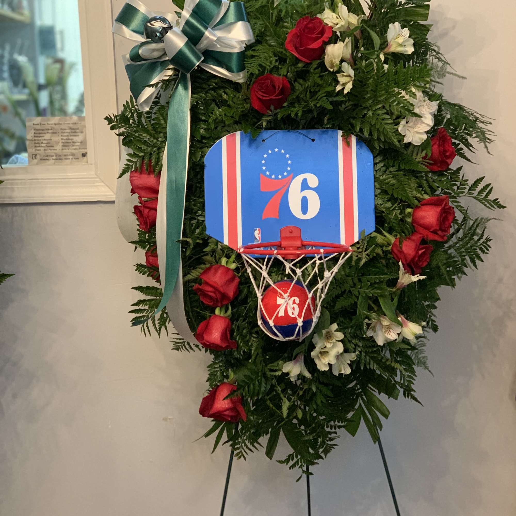Basketball-themed floral wreath with red roses and a blue 76ers sign