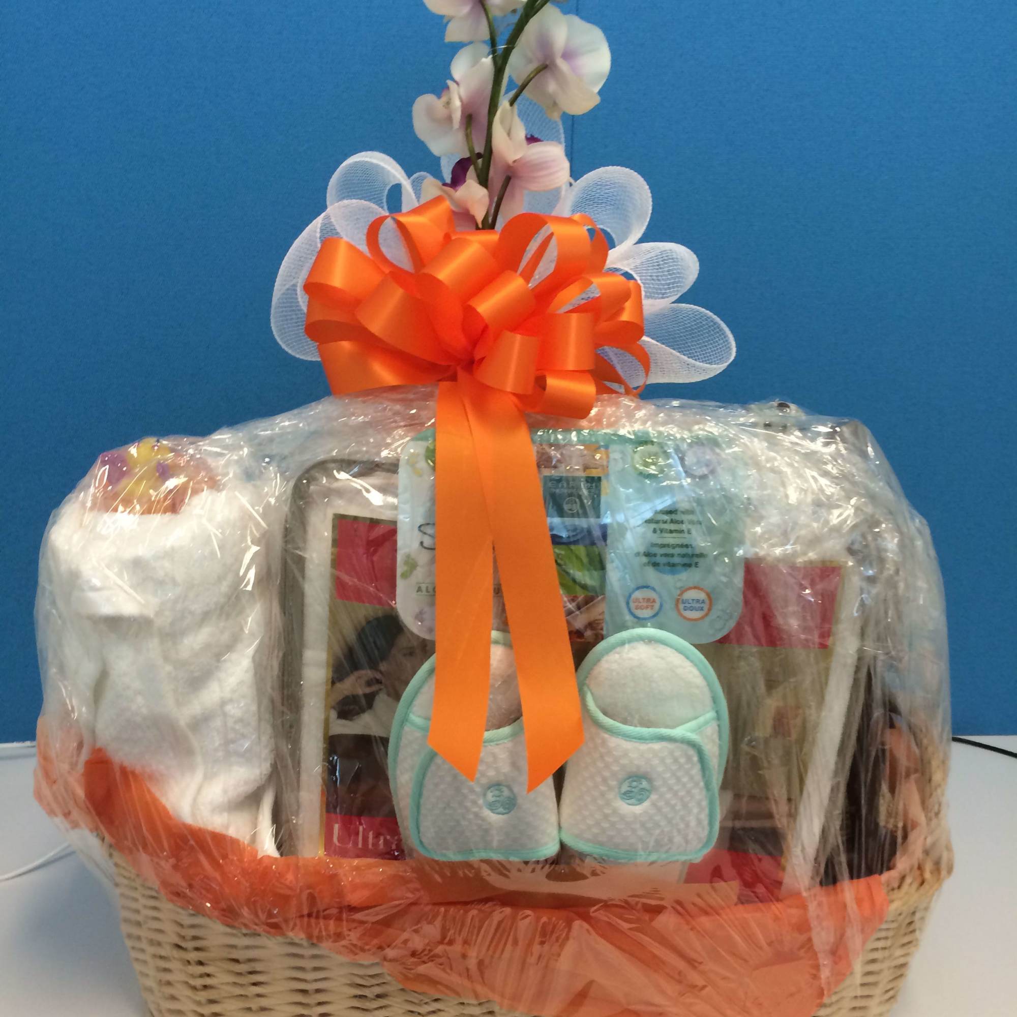 Gift basket with toiletries and a small orchid spray