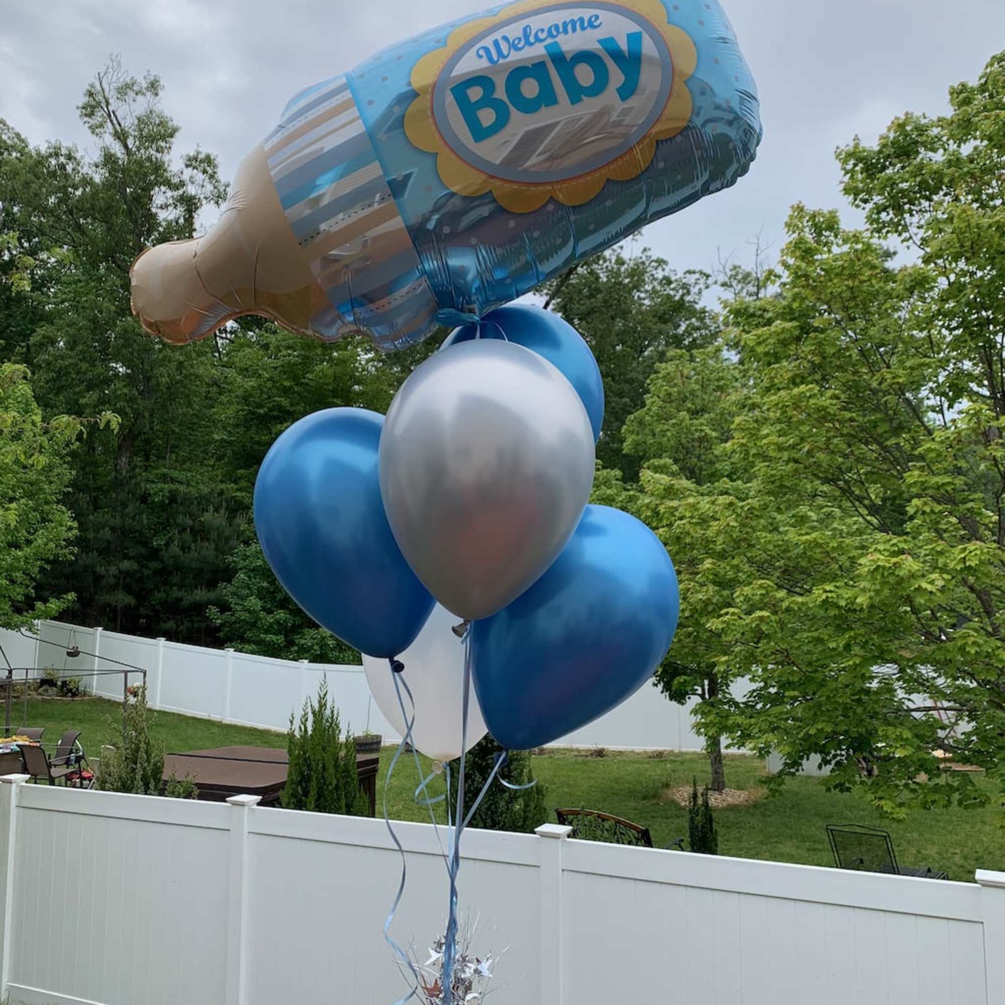 Baby bottle-shaped balloon bouquet with blue and silver balloons