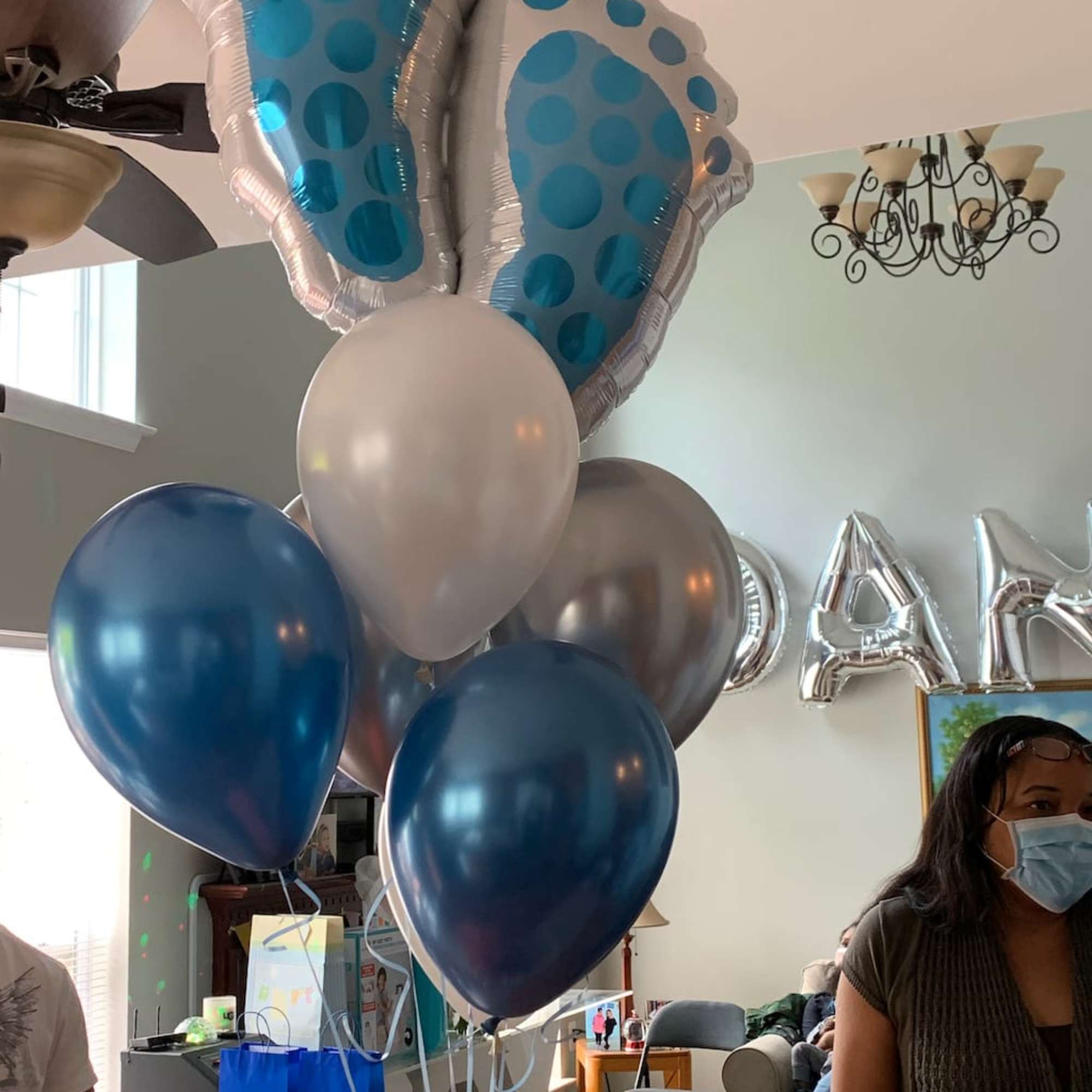 Cluster of blue, silver, and white balloons with large polka-dot foil balloons