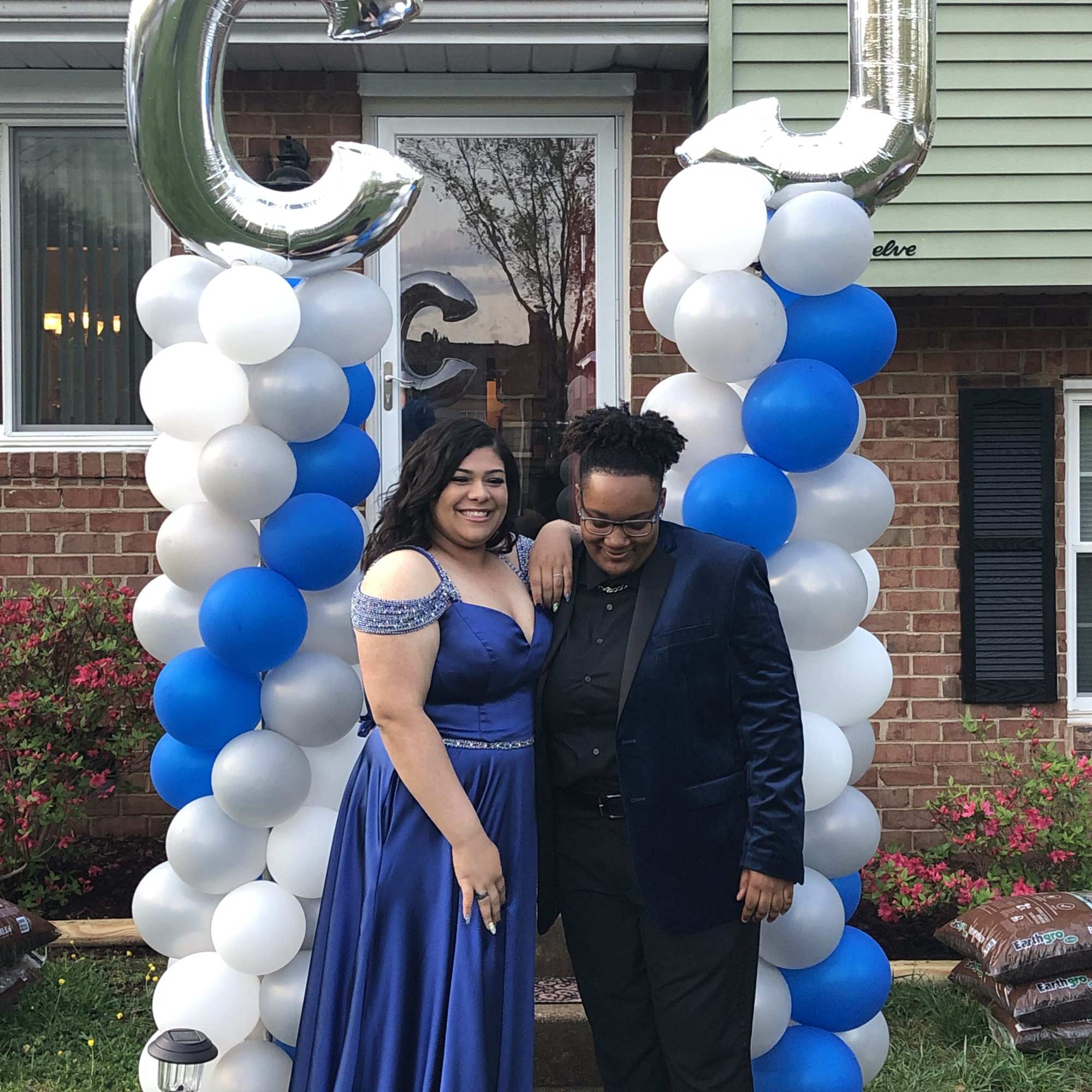 Blue and white balloon arch with silver letter balloons