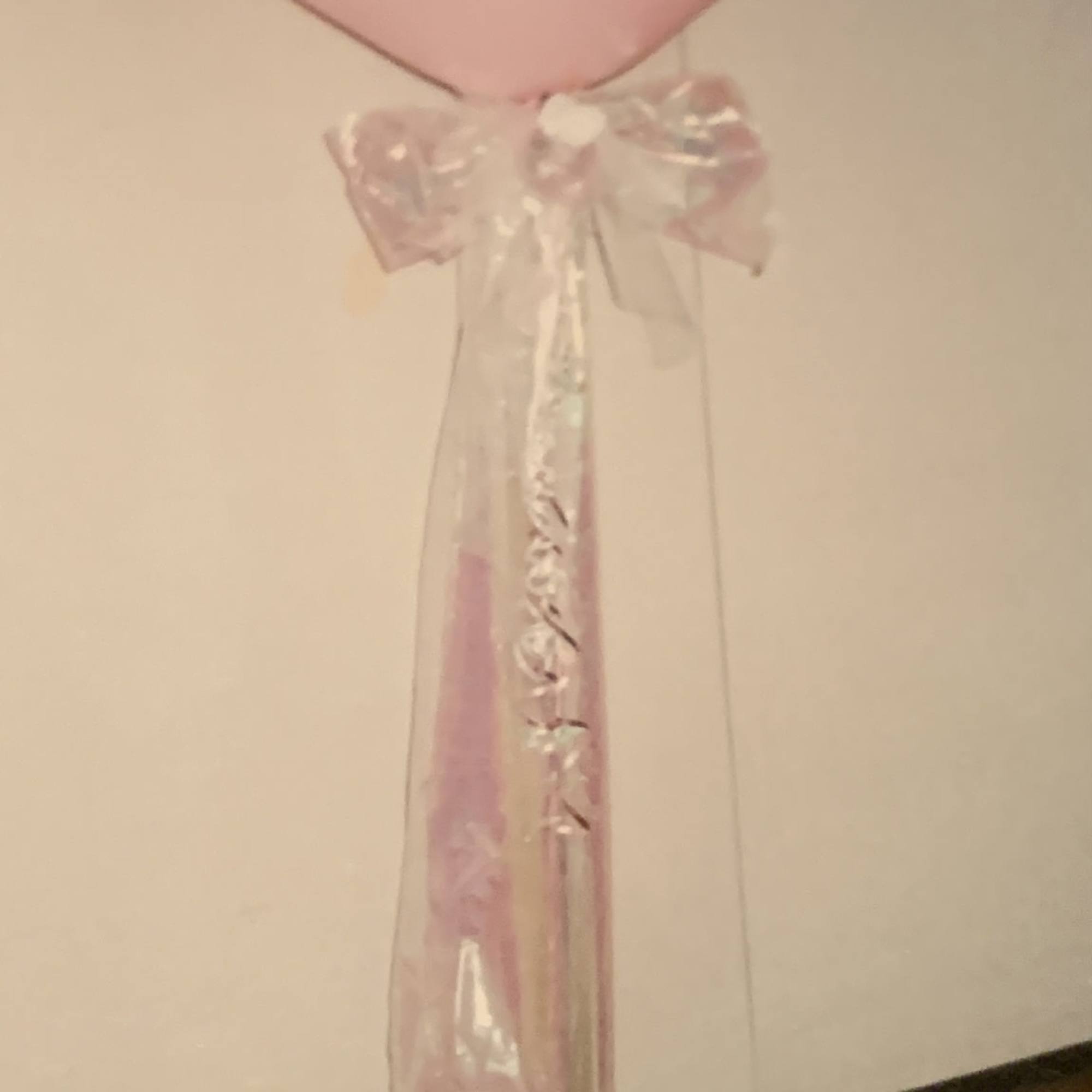 Pink heart-shaped balloon with a sheer ribbon tail