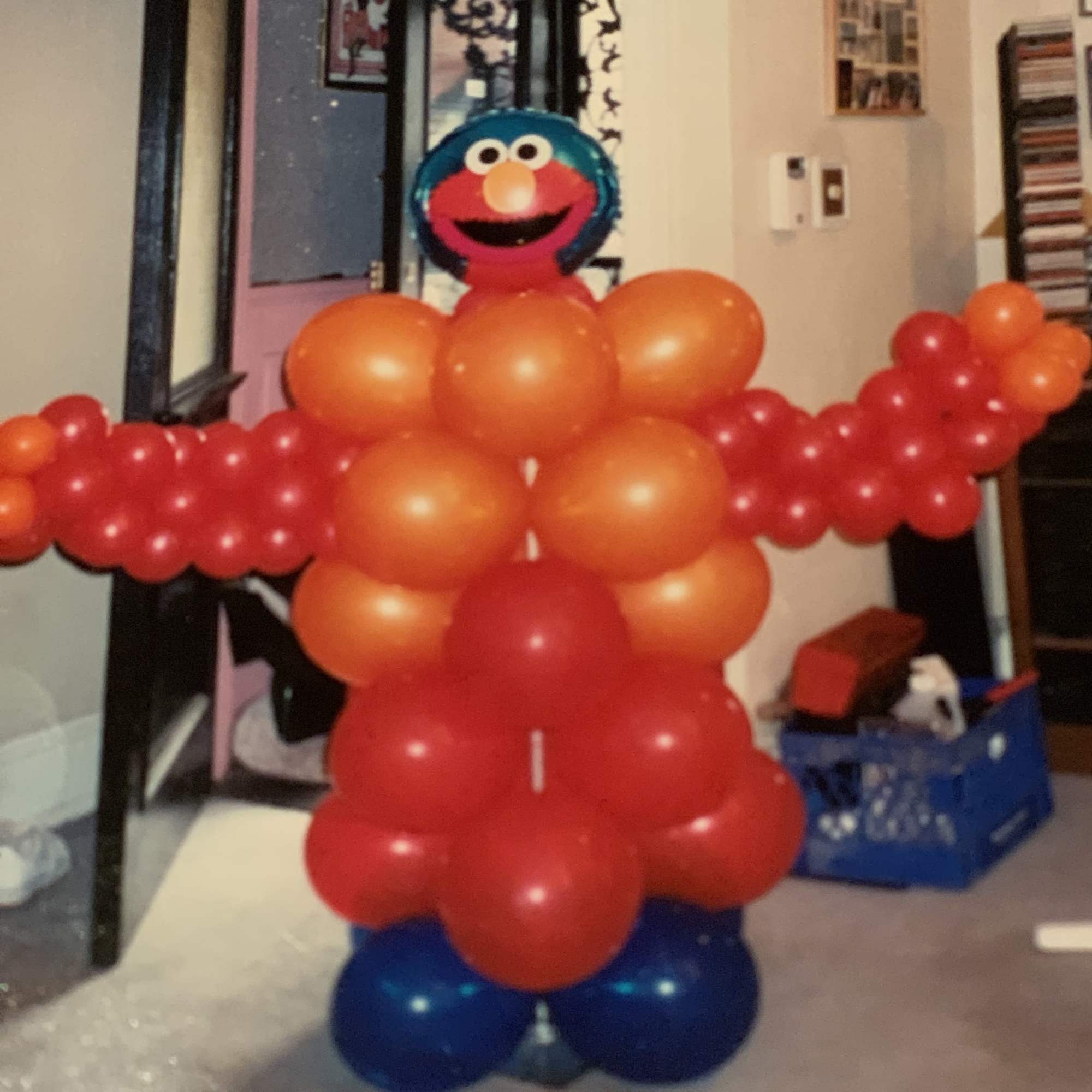 Sesame Street Elmo balloon figure made of red, orange, and blue balloons