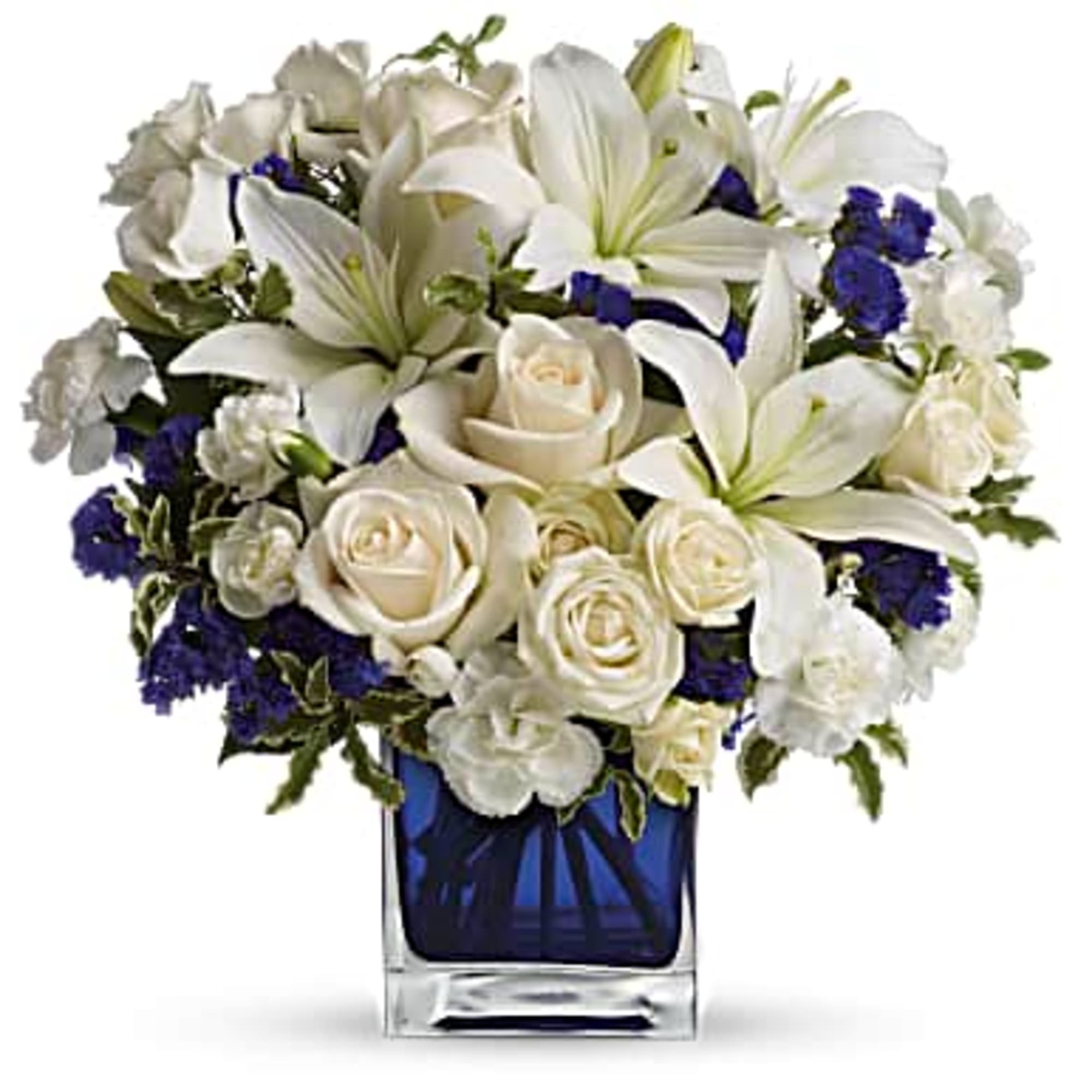 White lilies and roses arranged in a blue glass vase