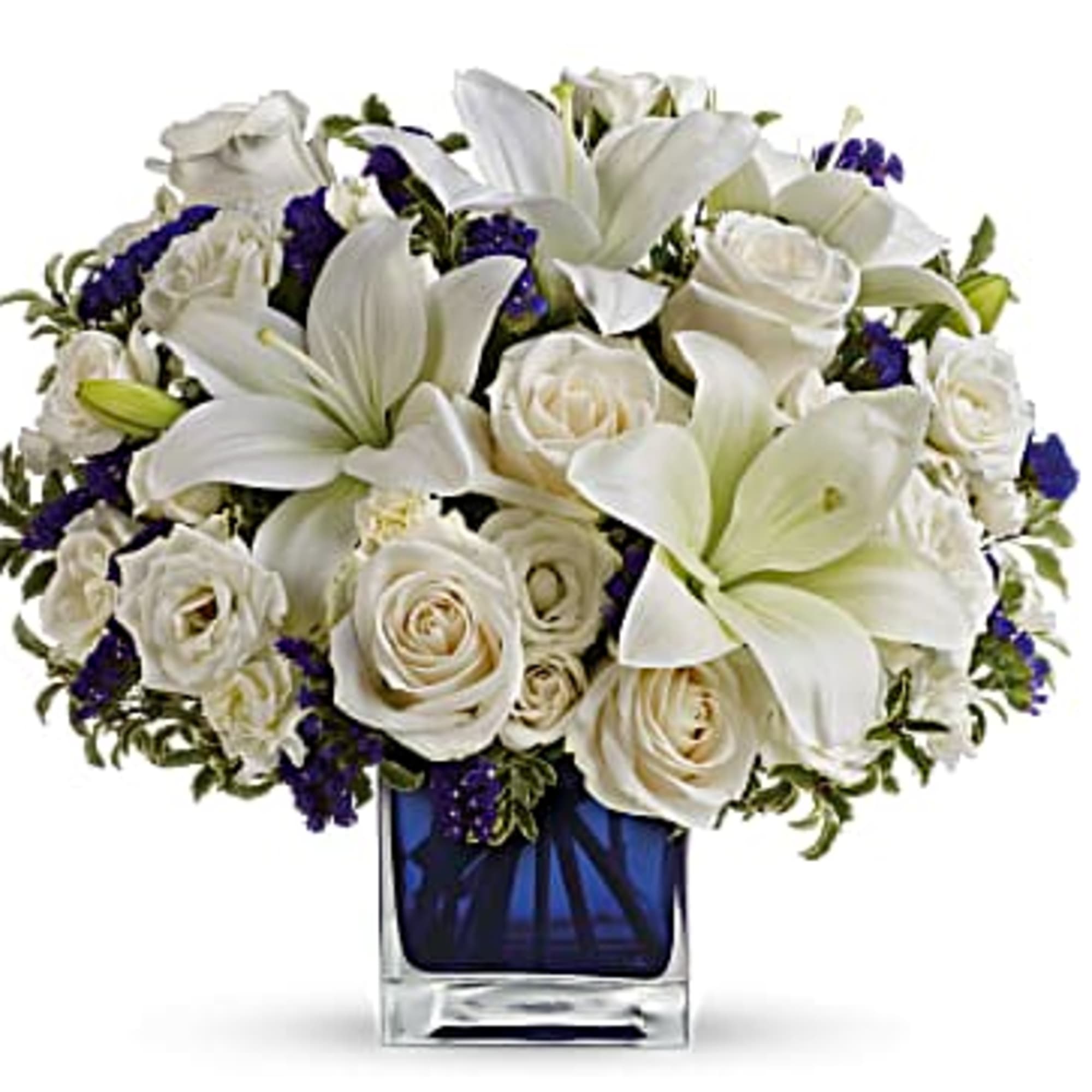White lilies and roses in a blue glass vase