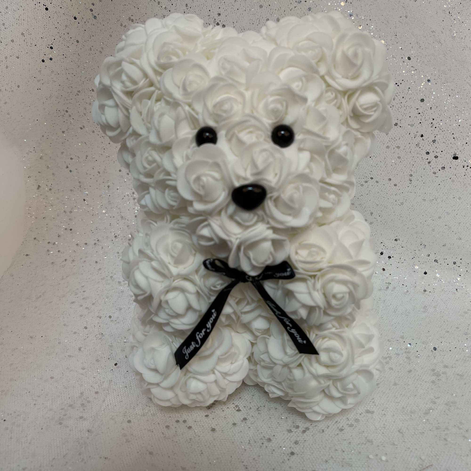 White rose teddy bear with black eyes and ribbon