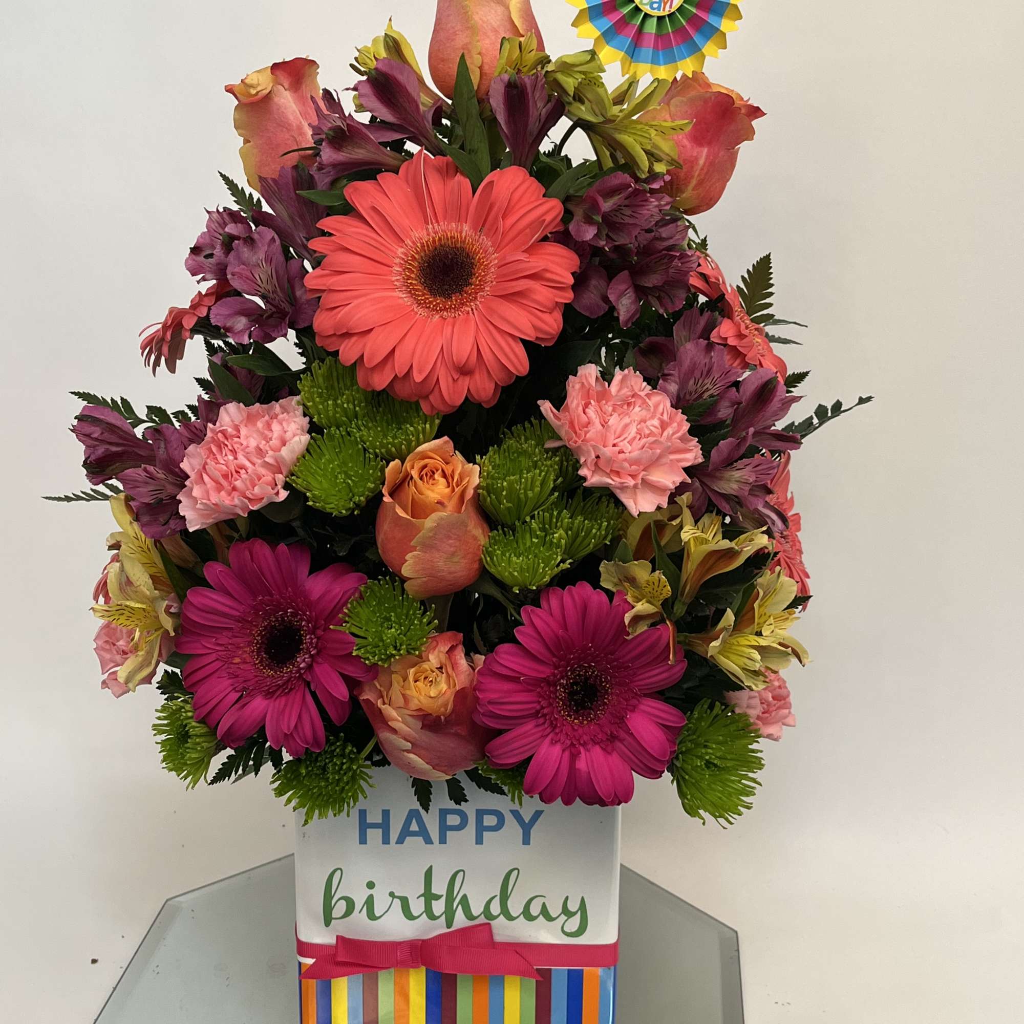 Bright mixed flower arrangement in a birthday gift box